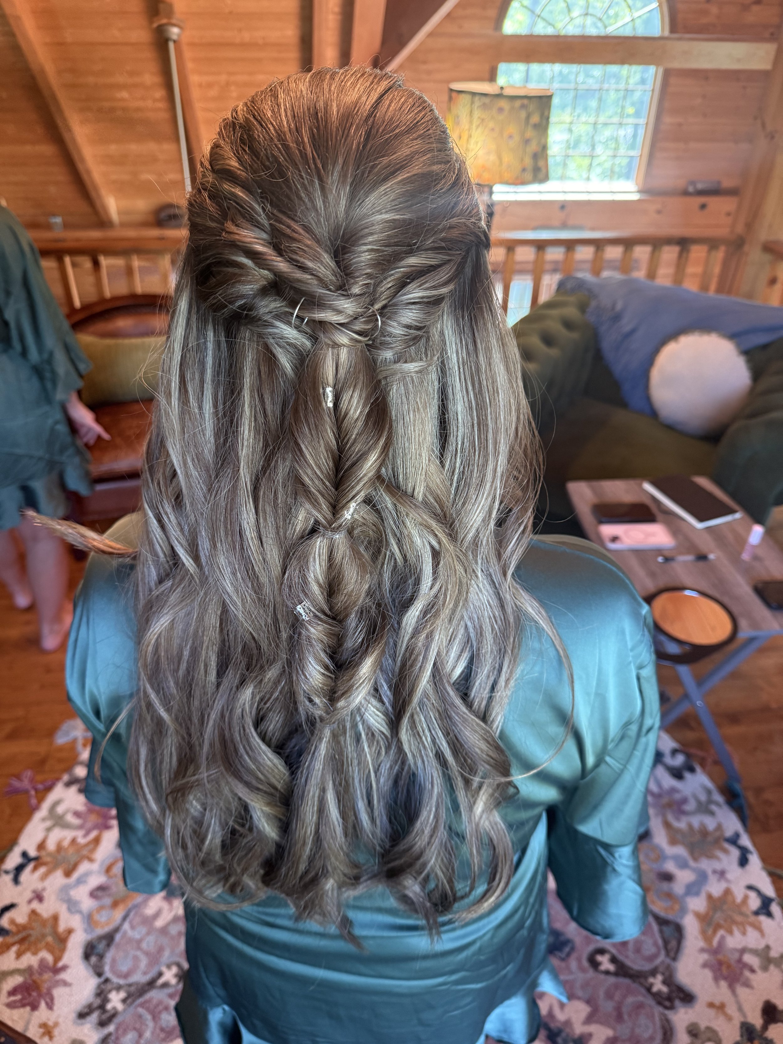 Romantic half-up bridal hairstyle with loose waves and delicate hair accessories