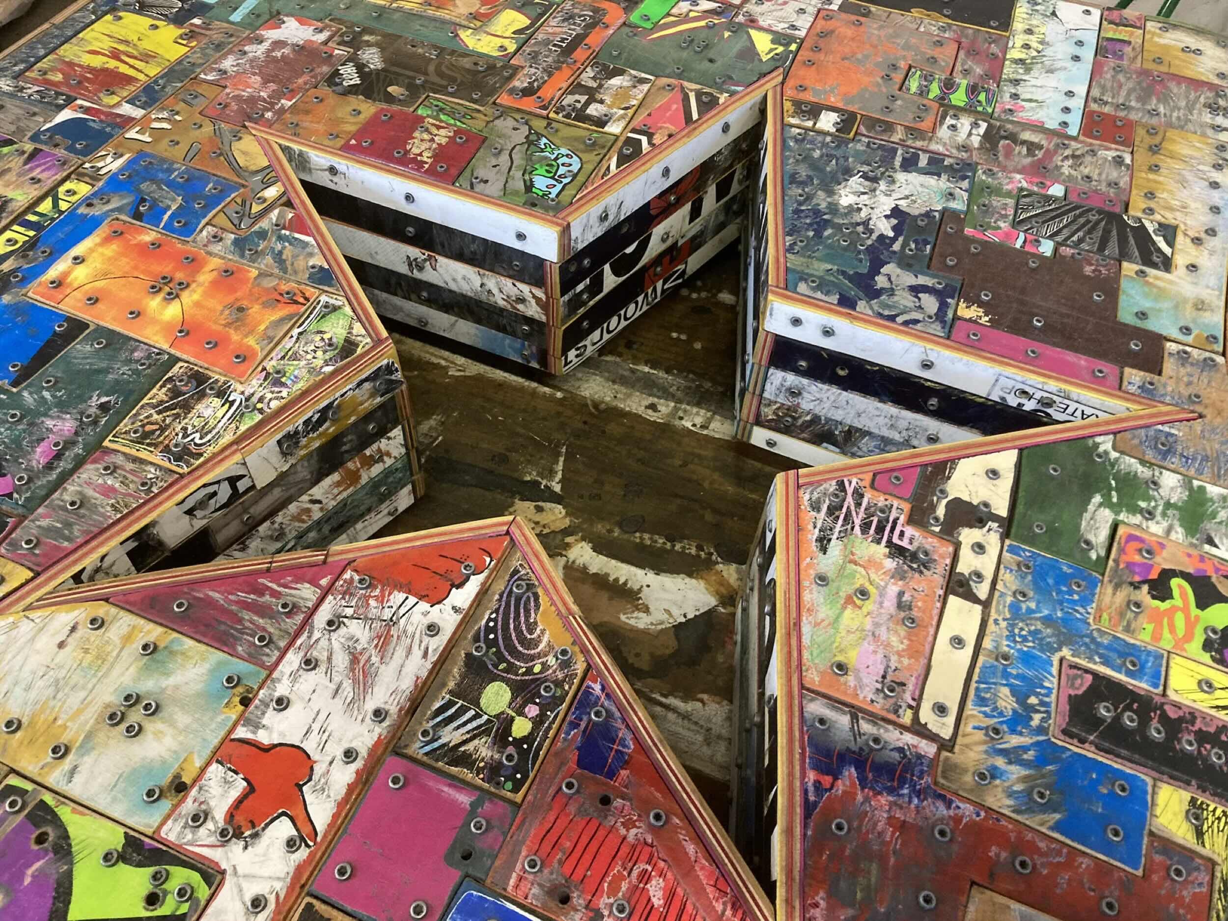 Detail of an art gallery wood sculpture made from reclaimed skateboard decks.