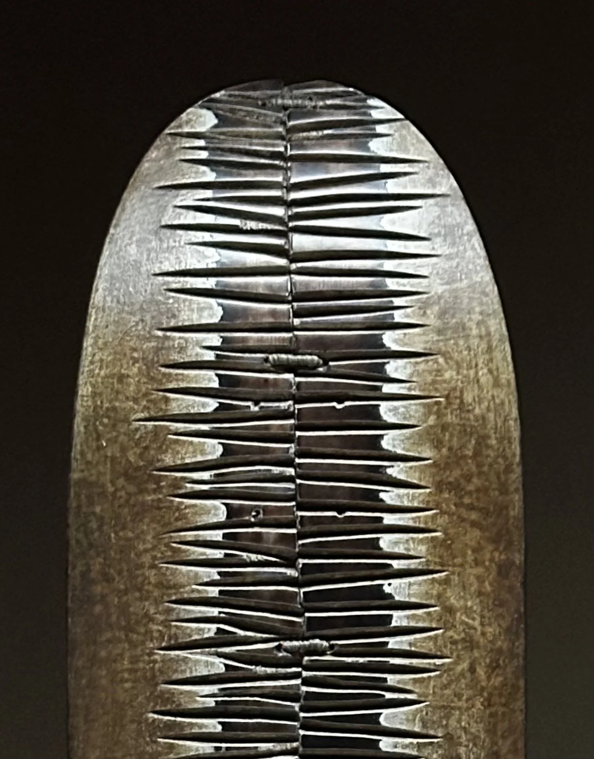 Close-up detail of the burned, built-up texture on George Peterson's LINGO Dark Band sculpture.