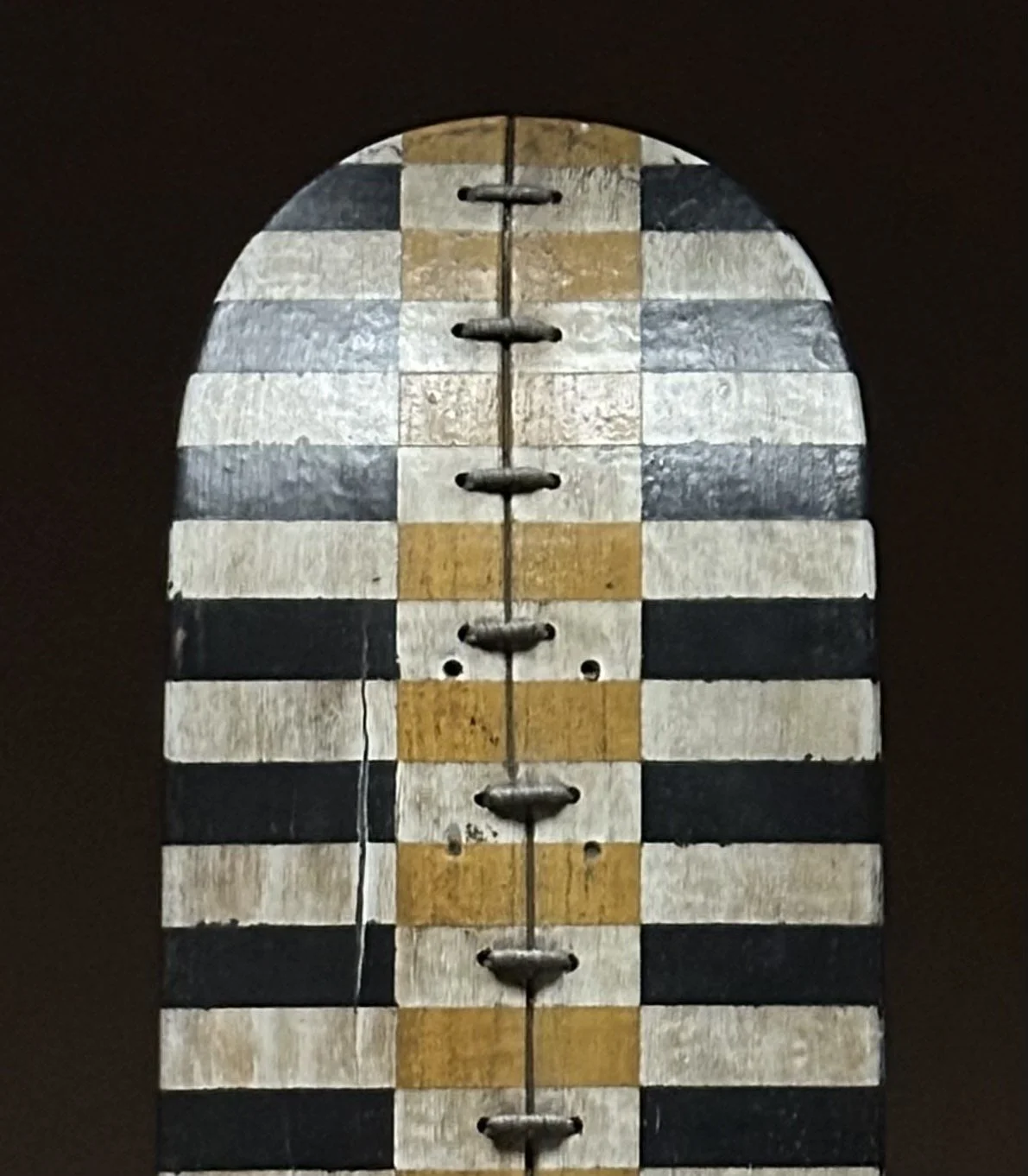 Close-up detail of the carved tri-color stripe pattern on George Peterson's LINGO Tri Stripe sculpture.