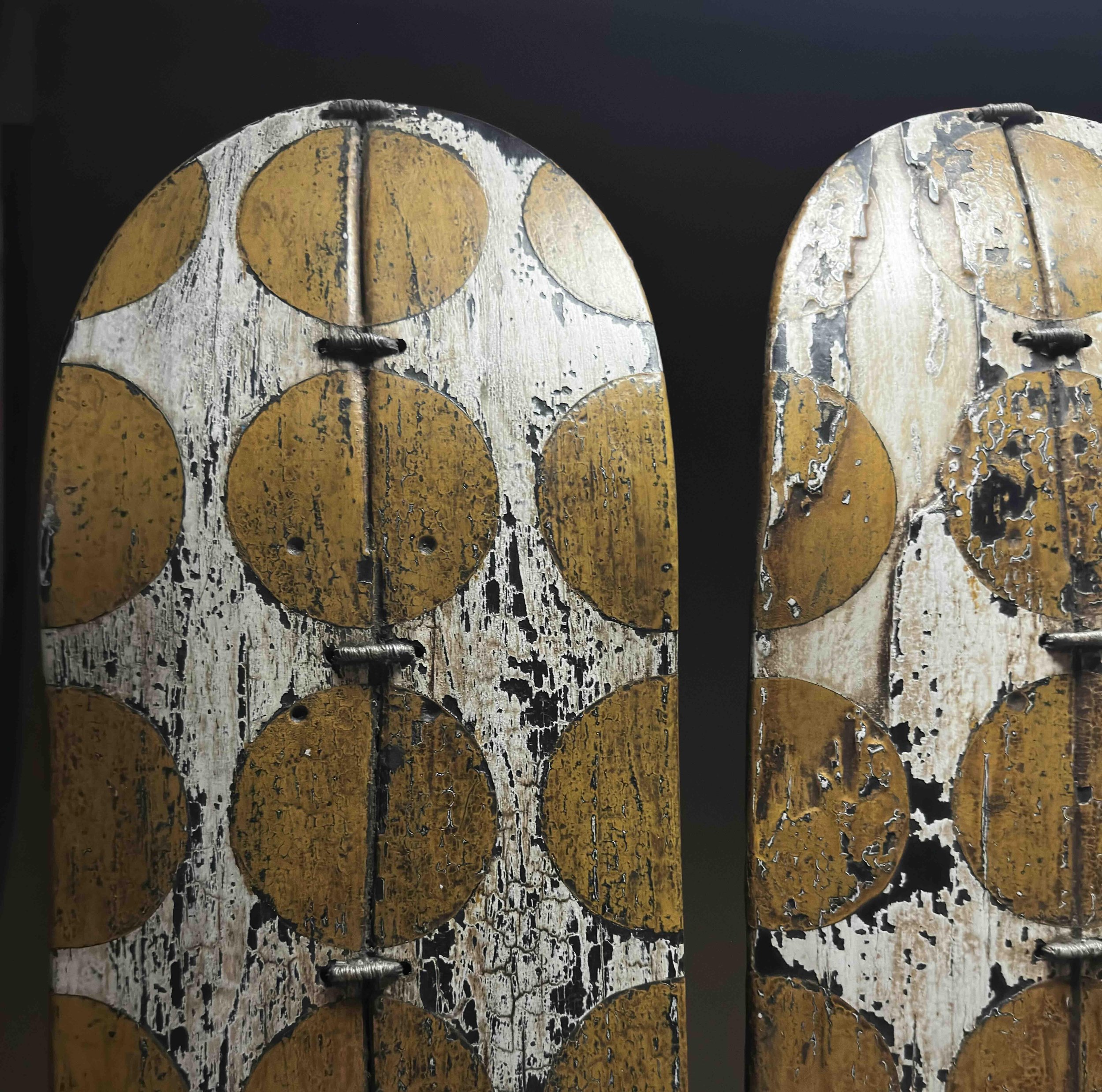 Close-up detail of the yellow and black dot pattern and panel connection on George Peterson's LINGO Dot Triptych sculpture.