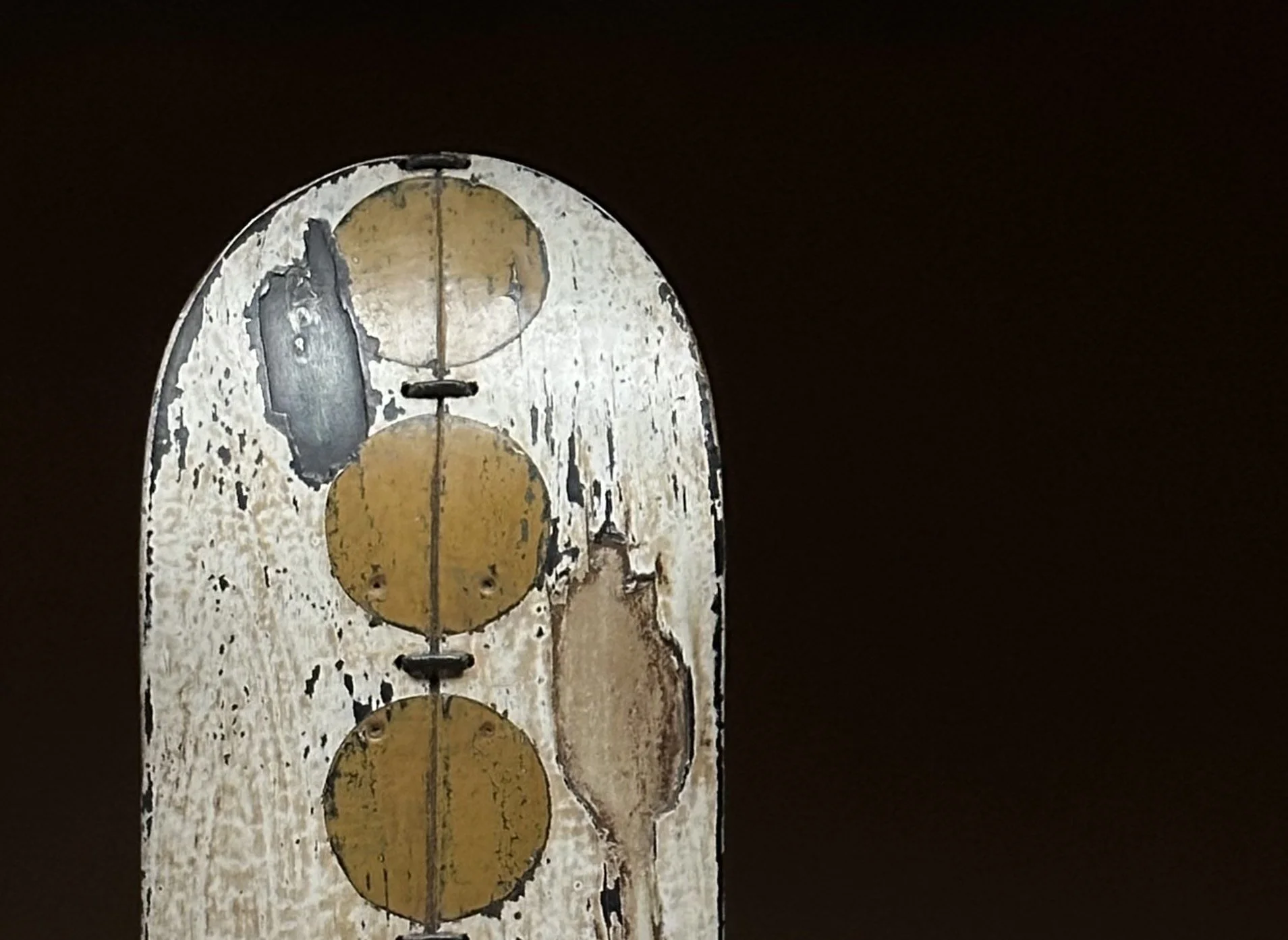 Close-up of the hand-placed yellow dot row and worn deck texture on George Peterson's LINGO Yellow Row sculpture.