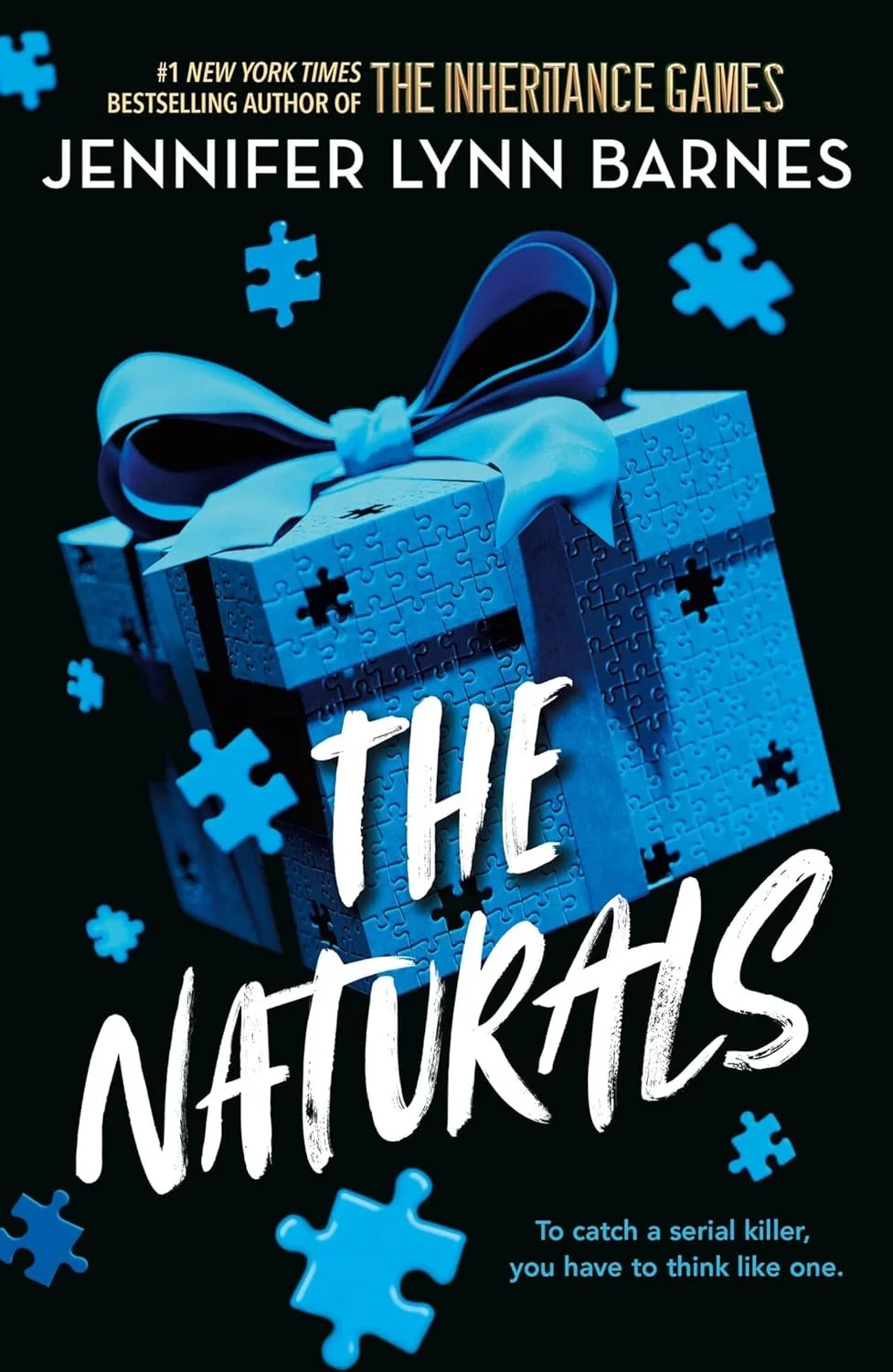 Book cover for 'The Naturals' by Jennifer Lynn Barnes, featuring a blue jigsaw puzzle box with a ribbon and scattered puzzle pieces, against a dark background.