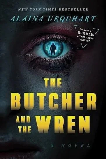 Book cover for 'The Butcher and the Wren' by Alina Urquhart, featuring a close-up of a human eye with a reflection of a person inside the eye.