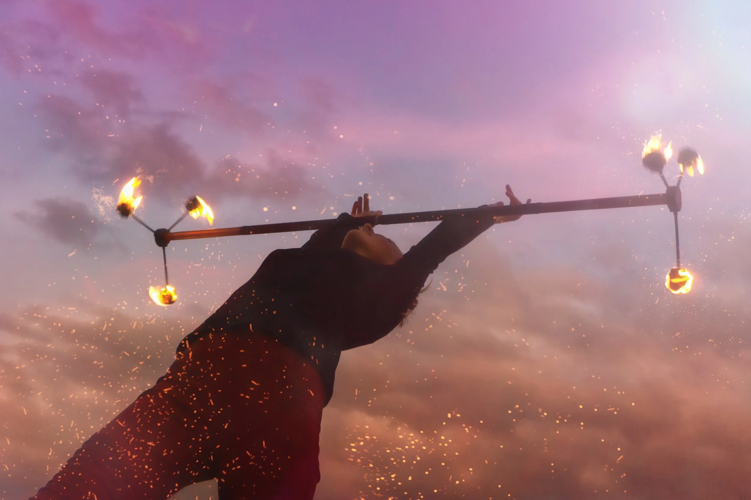 Elena Tinkloh performing with a fire dragon staff, leaning back gracefully — flow arts and psychology
