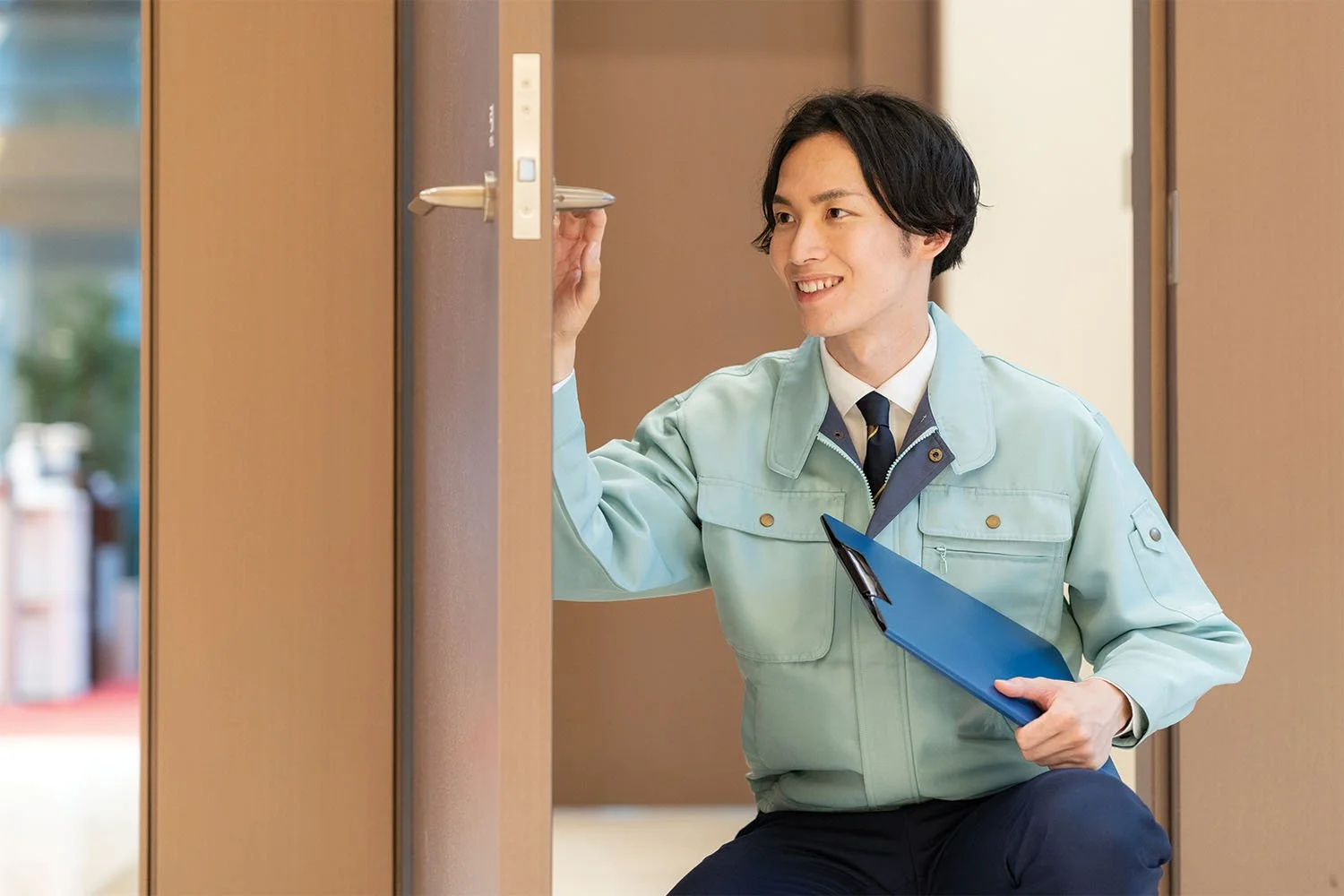 Hotel engineer inspecting a door lock system.