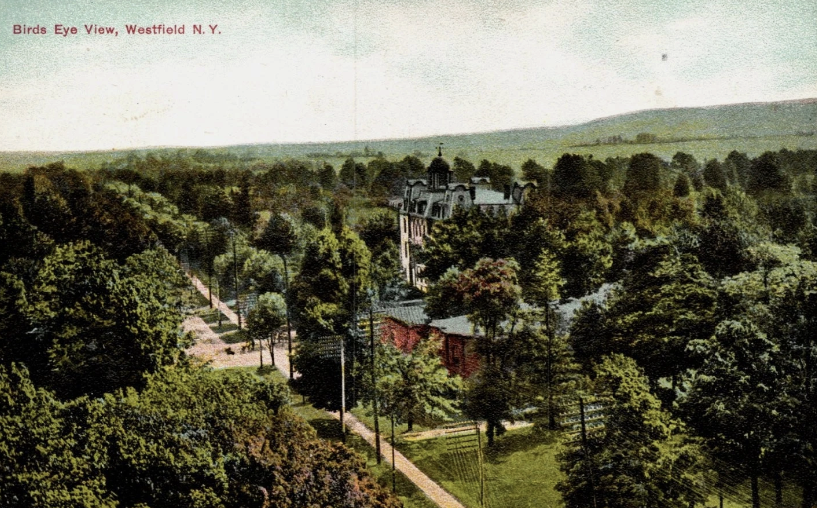 A vintage aerial view of Westfield, New York, showing a park with walking paths, trees, and a church in the background, titled 'Birds Eye View, Westfield N. Y.'