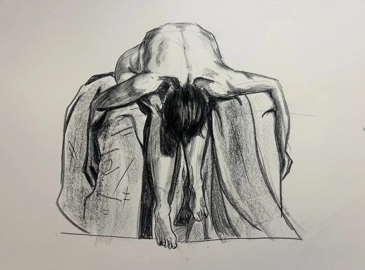 A charcoal sketch of a person with long hair, sitting on a platform draped in cloth. Their head and torso are bowed down and arms resting on either side of the platform, exposing their bony back.