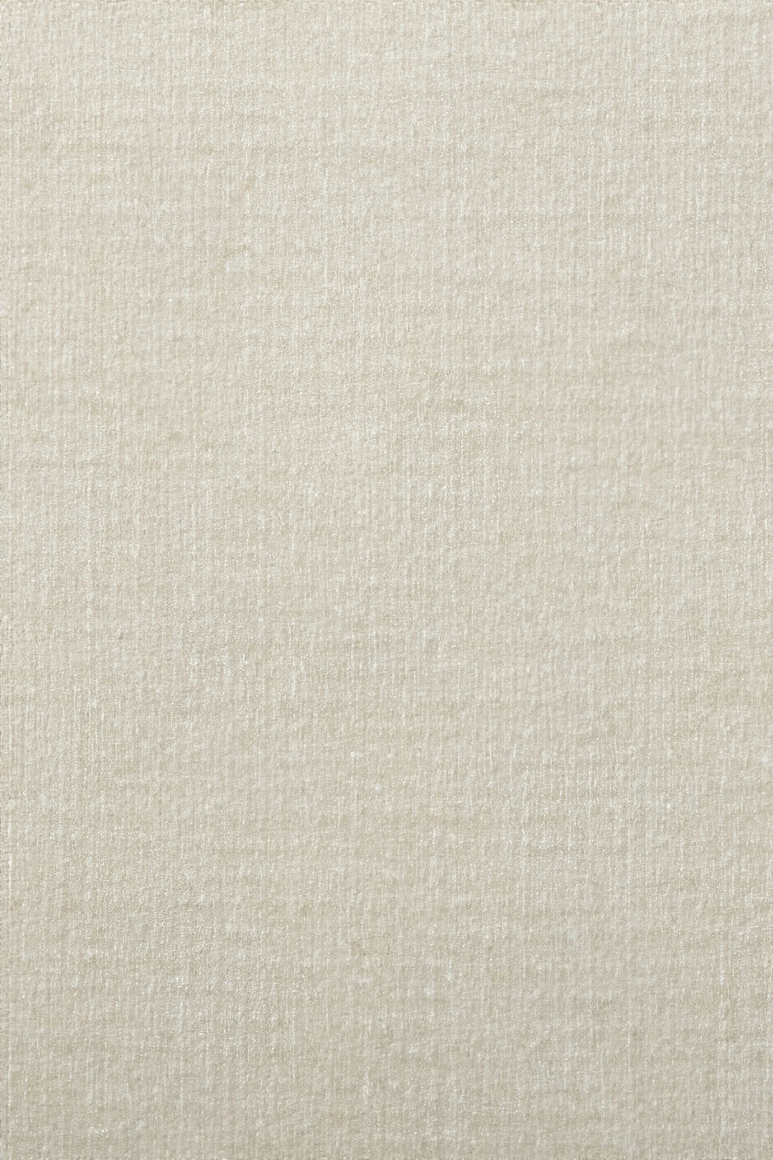 Een close-up van een effen, beige textieloppervlak met een subtiele structuur.