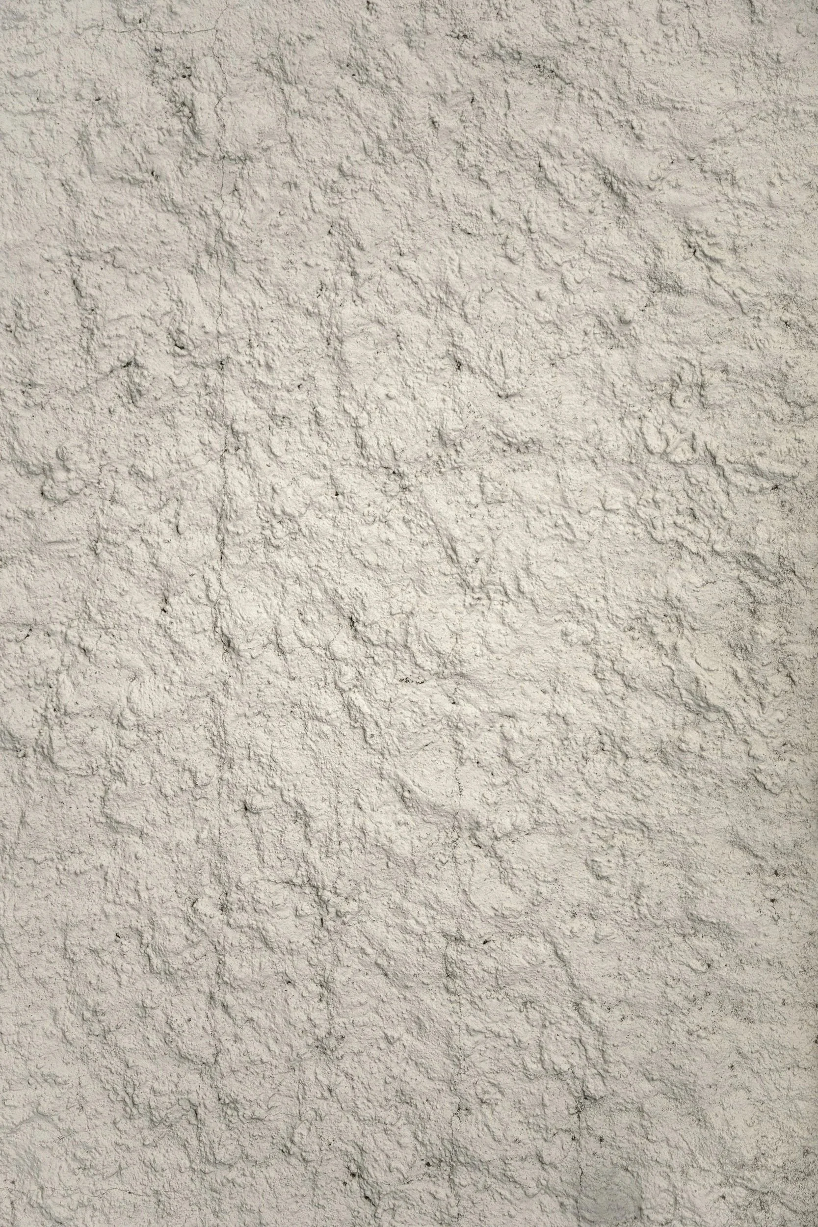 Een grijze, ruwe muur met een grove textuur.