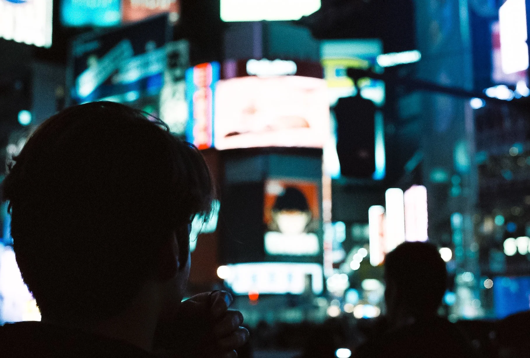 Abstract street photography featuring bokeh and blurred neon lights from Tokyo city streets at night.