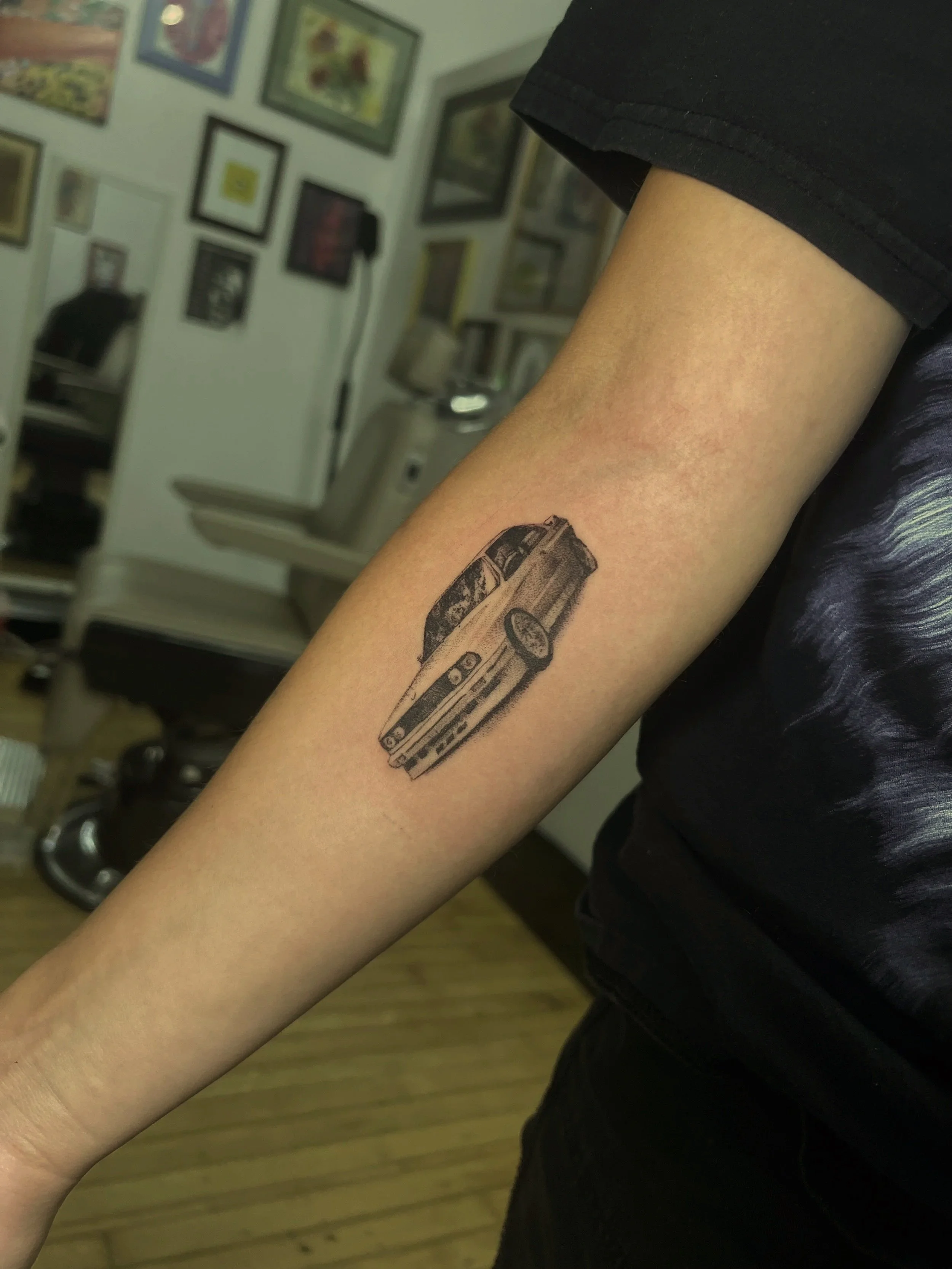 Tattoo of a vintage car on a person's arm. Reference to Nostalgia Ultra by Frank Ocean
