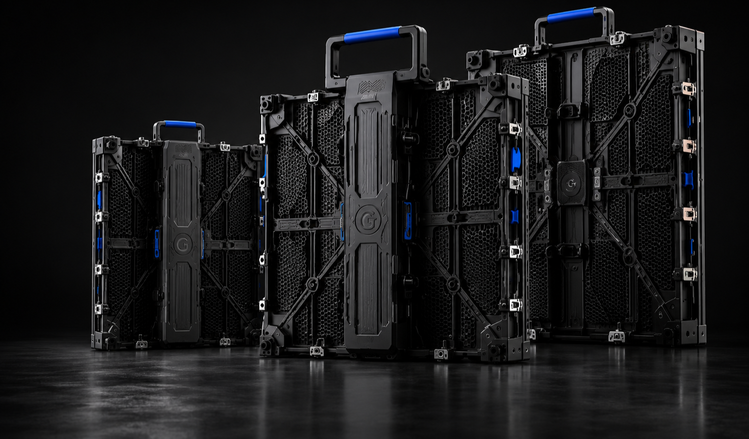 Four black LED display panels with blue accents, arranged in increasing size from left to right, placed on a dark surface against a black background.
