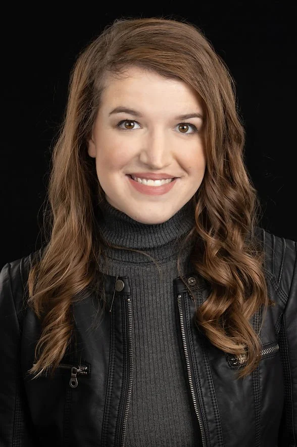 Ashley Jellison, the executive director of the Colorado Children's Alliance, is a young woman with wavy brown hair and fair skin.