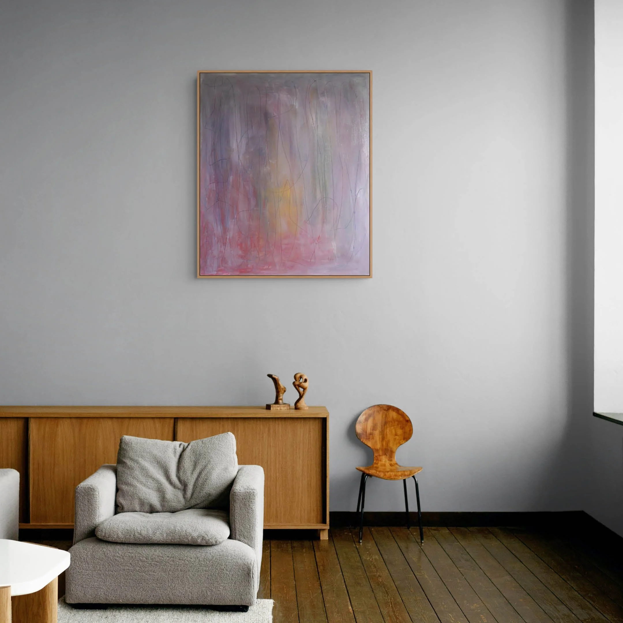 Room view of abstract oil paint and oil stick painting. Features soft blurred painting in very muted tones of purple grey, red and yellow with graphite pencil lines on top.