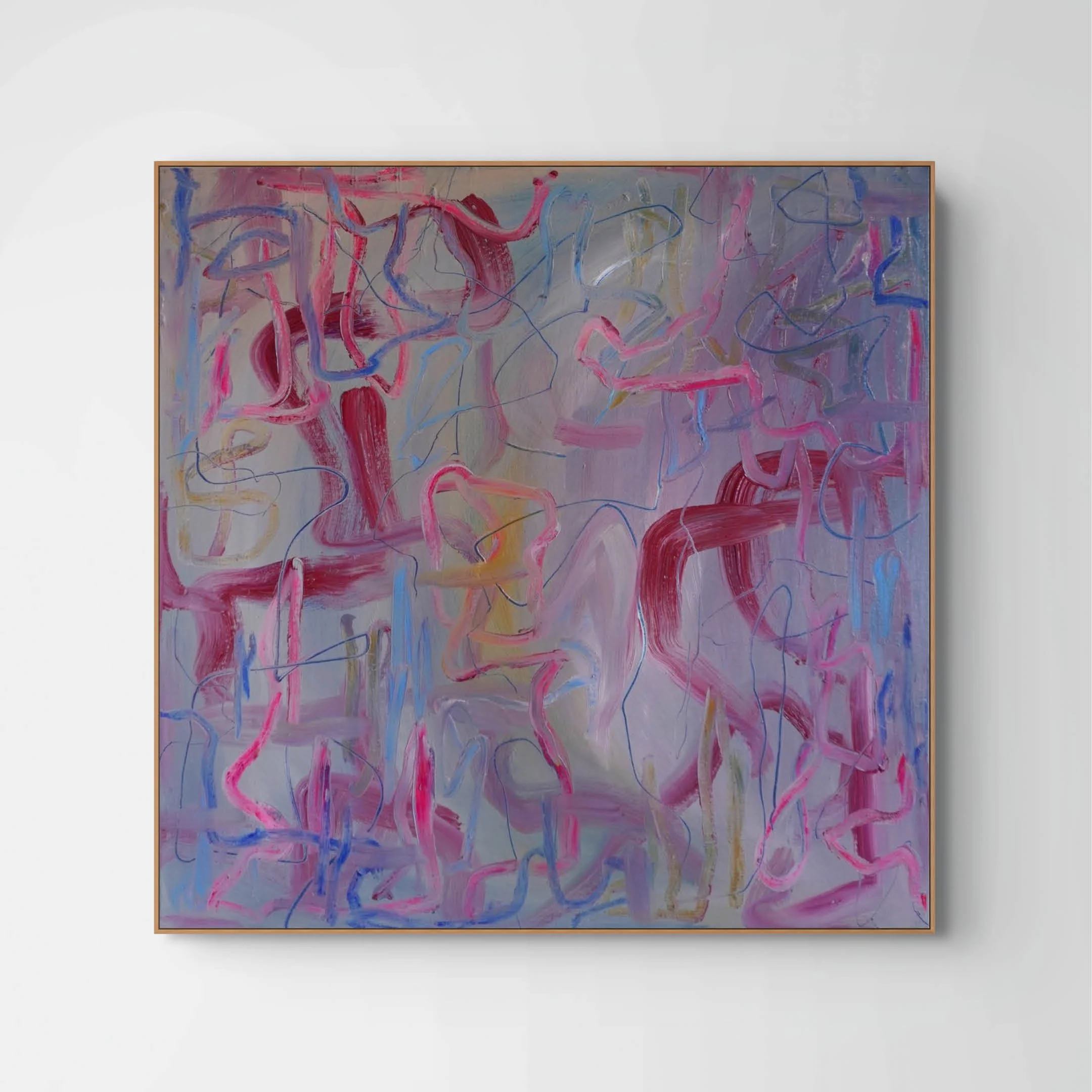 An abstract painting with colorful, swirling lines and shapes in pink, red, purple, yellow, and blue on a light background, framed and mounted on a white wall.