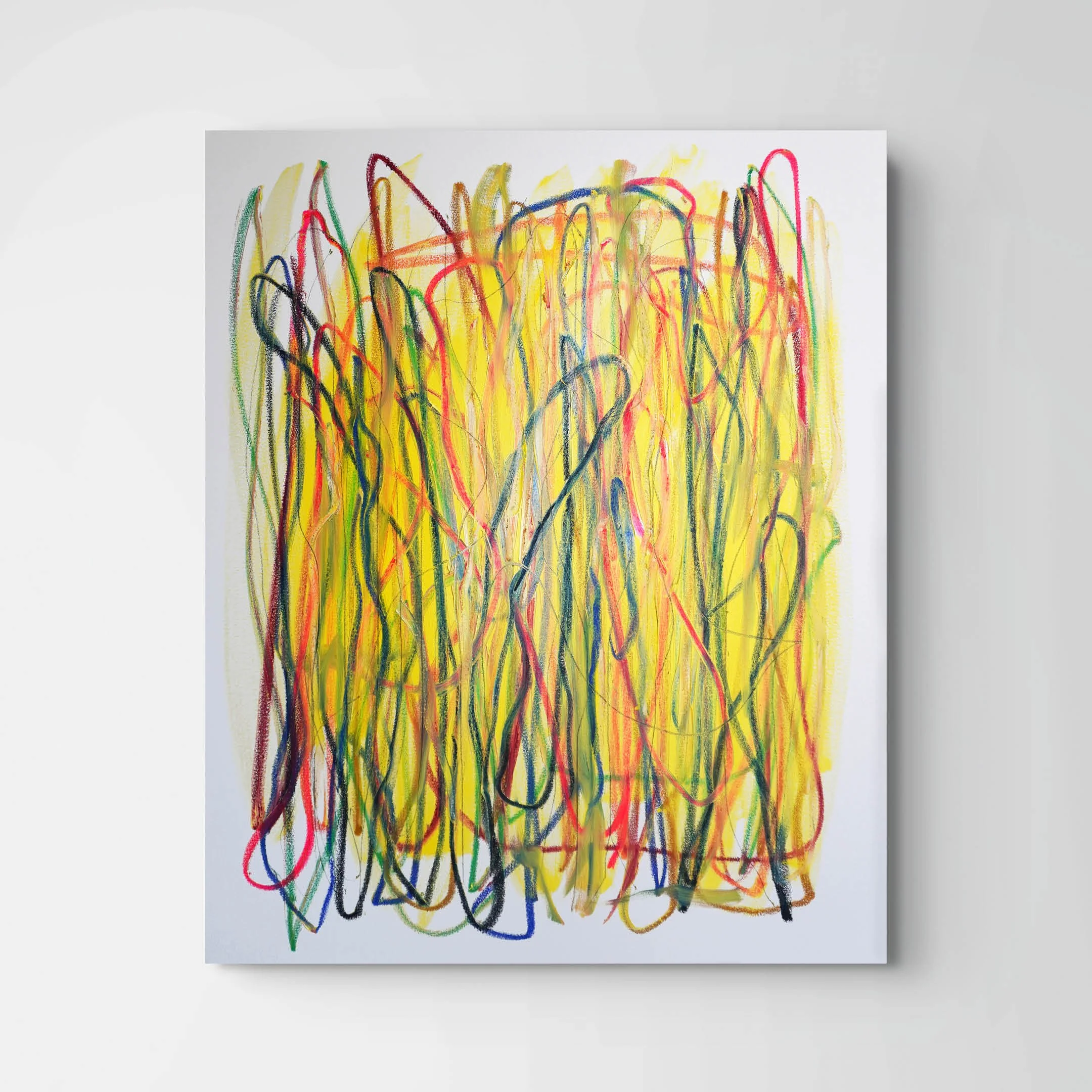 Colorful abstract crayon drawing on white paper with overlapping wavy and scribbled lines in multiple colors