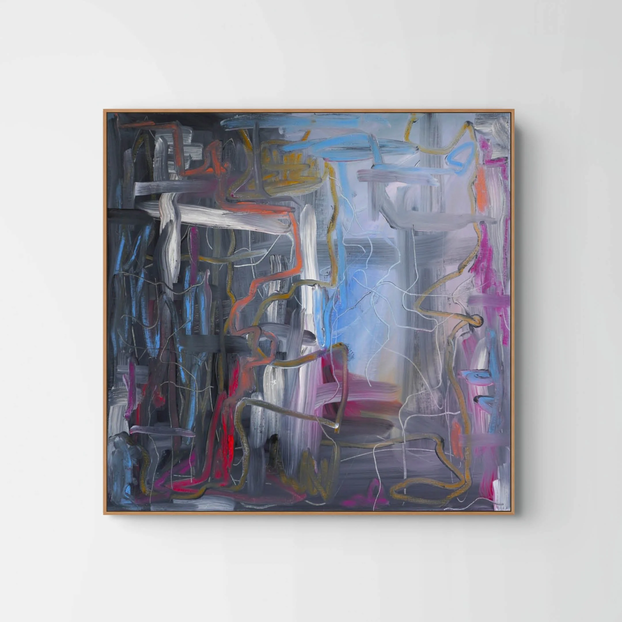Abstract modern painting with bold, colorful brushstrokes on a large canvas framed in wood, hung on a white wall.