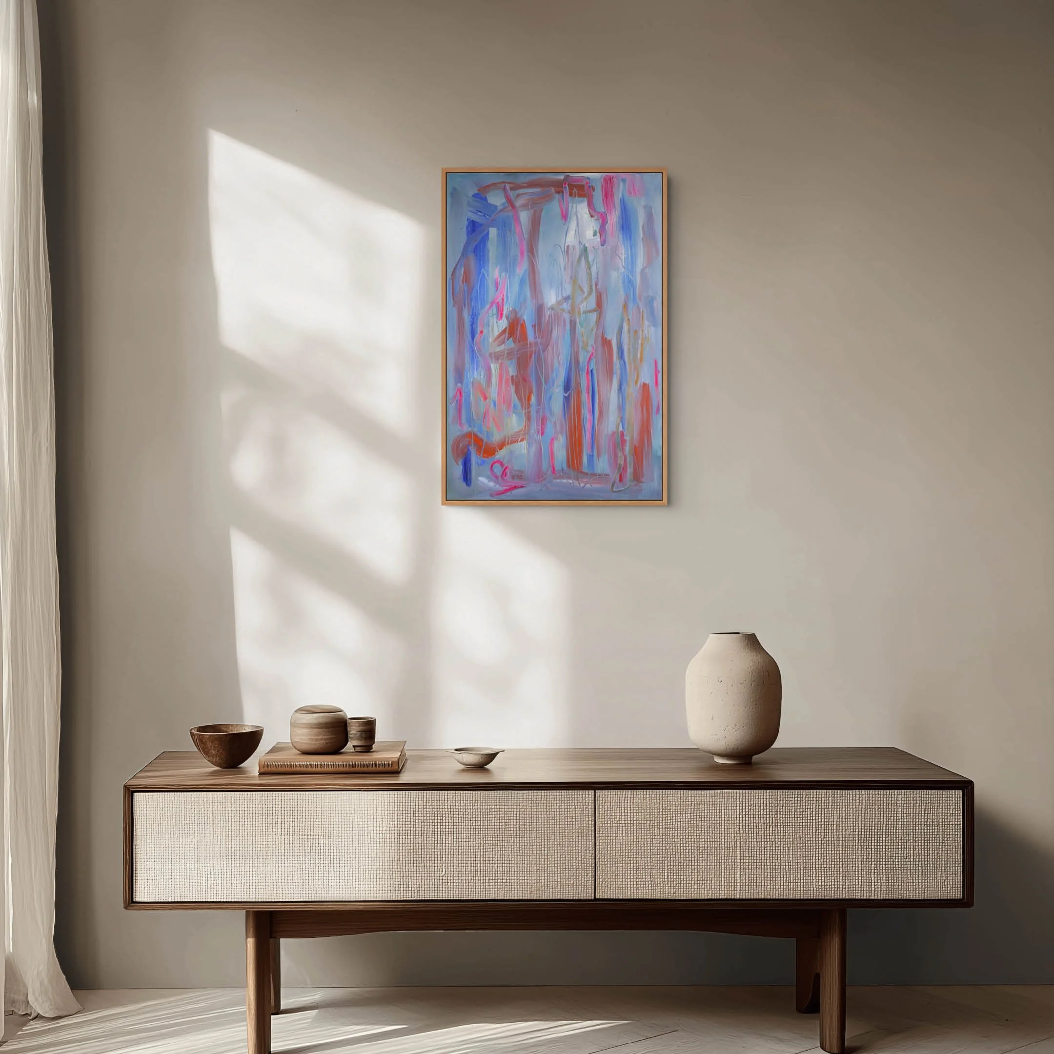A wooden sideboard with a textured front, topped with three ceramic vases and bowls, against a plain wall with abstract painting and a lamp nearby.