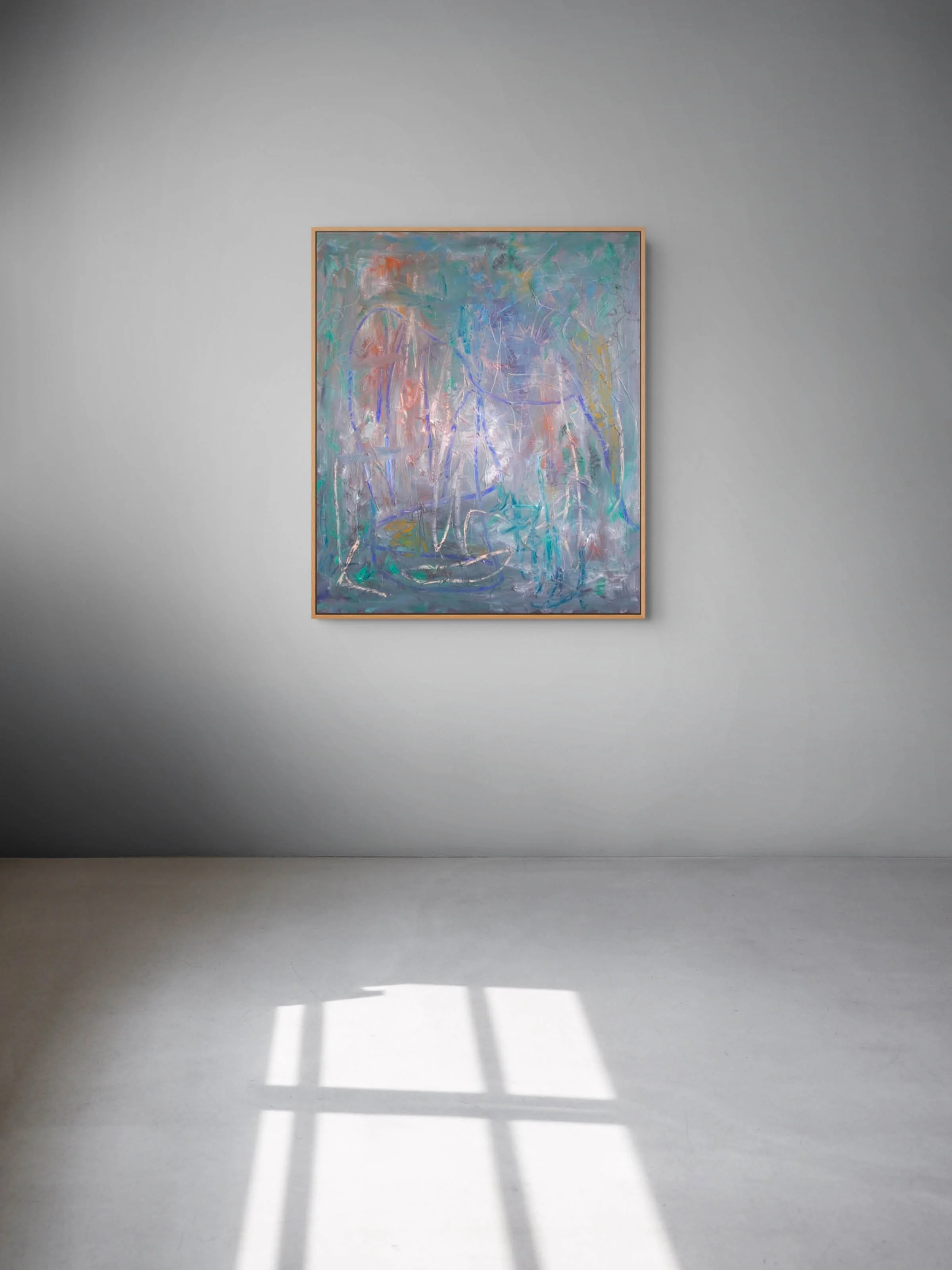 An abstract painting with pastel colors hanging on a plain wall, with sunlight casting shadows on the floor.