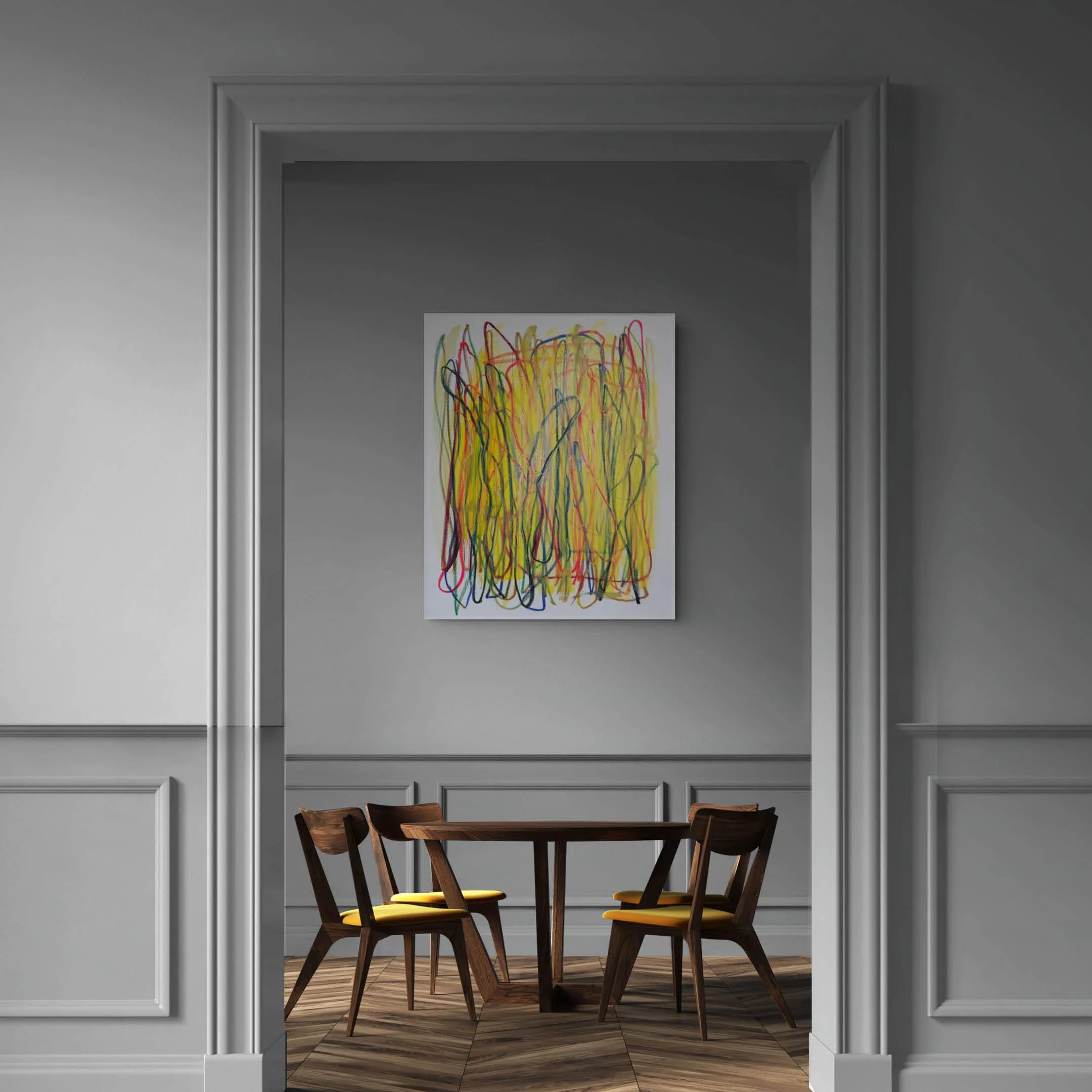 Interior view of a dining area with a wooden table and six chairs, seen through a doorway in a room with gray walls and white wainscoting. A colorful abstract painting hangs on the far wall.