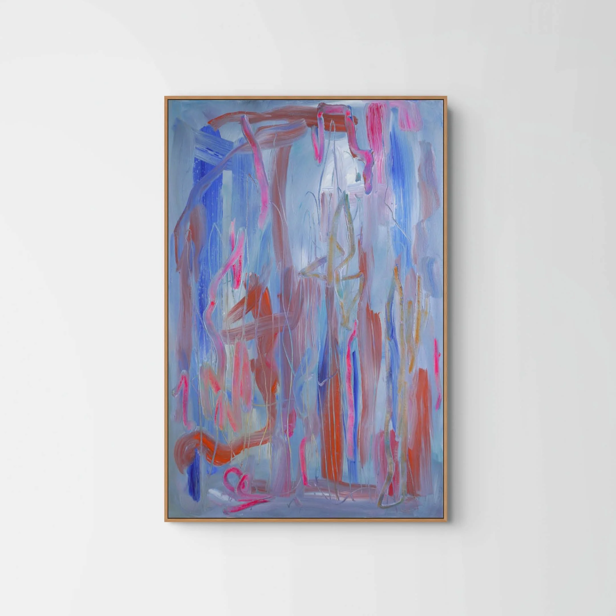 An abstract painting with bold brushstrokes in shades of blue, pink, red, and white, framed in a light wooden frame hanging on a white gallery wall.