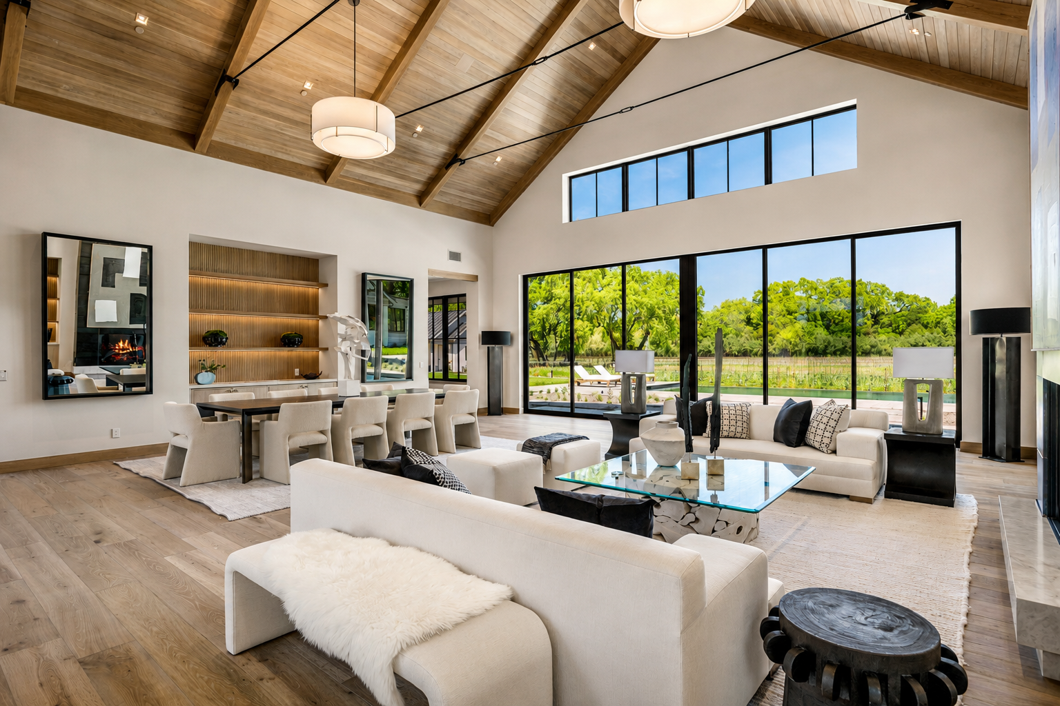 Great room at Trubody Ranch in Napa Valley featuring expansive glass doors, vineyard and garden views, a warm wood ceiling, and a contemporary open-plan interior.