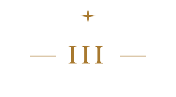 Close-up of a black clock face with gold Roman numerals II and III, gold accents, and a gold outline of a star at the top.