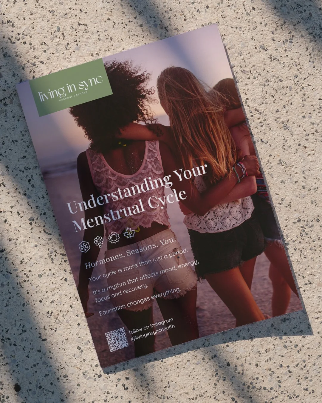 A pamphlet titled 'Understanding Your Menstrual Cycle' shows two young women with their arms around each other on a beach at sunset, wearing casual summer clothing.