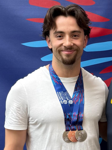 JP Swim Academy swimming instructor with medals from the British Masters Championships.