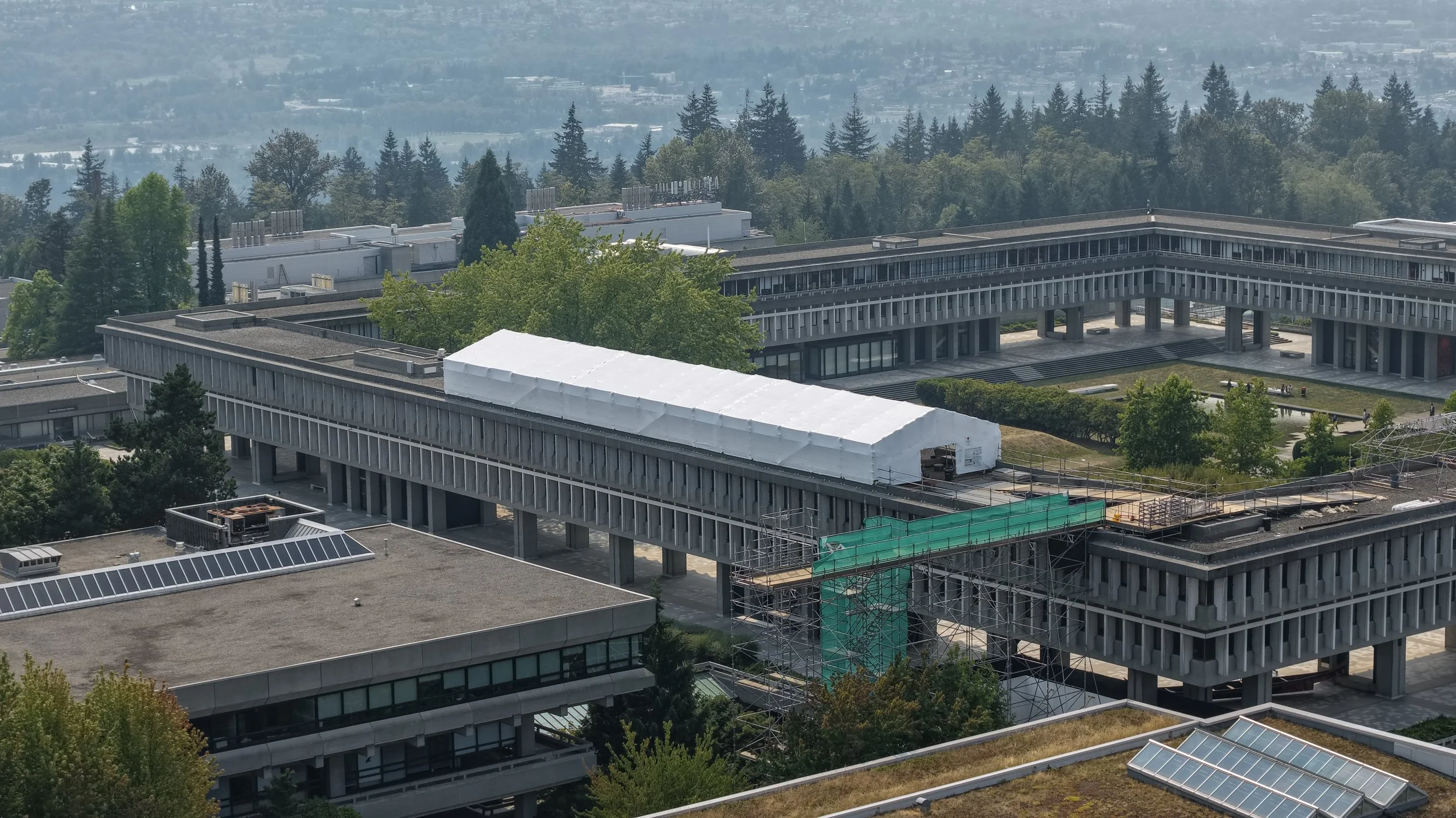 Aerial drone photo of Simon Fraser University in Burnaby, BC showing a commercial scaffold and shrink wrap containment project