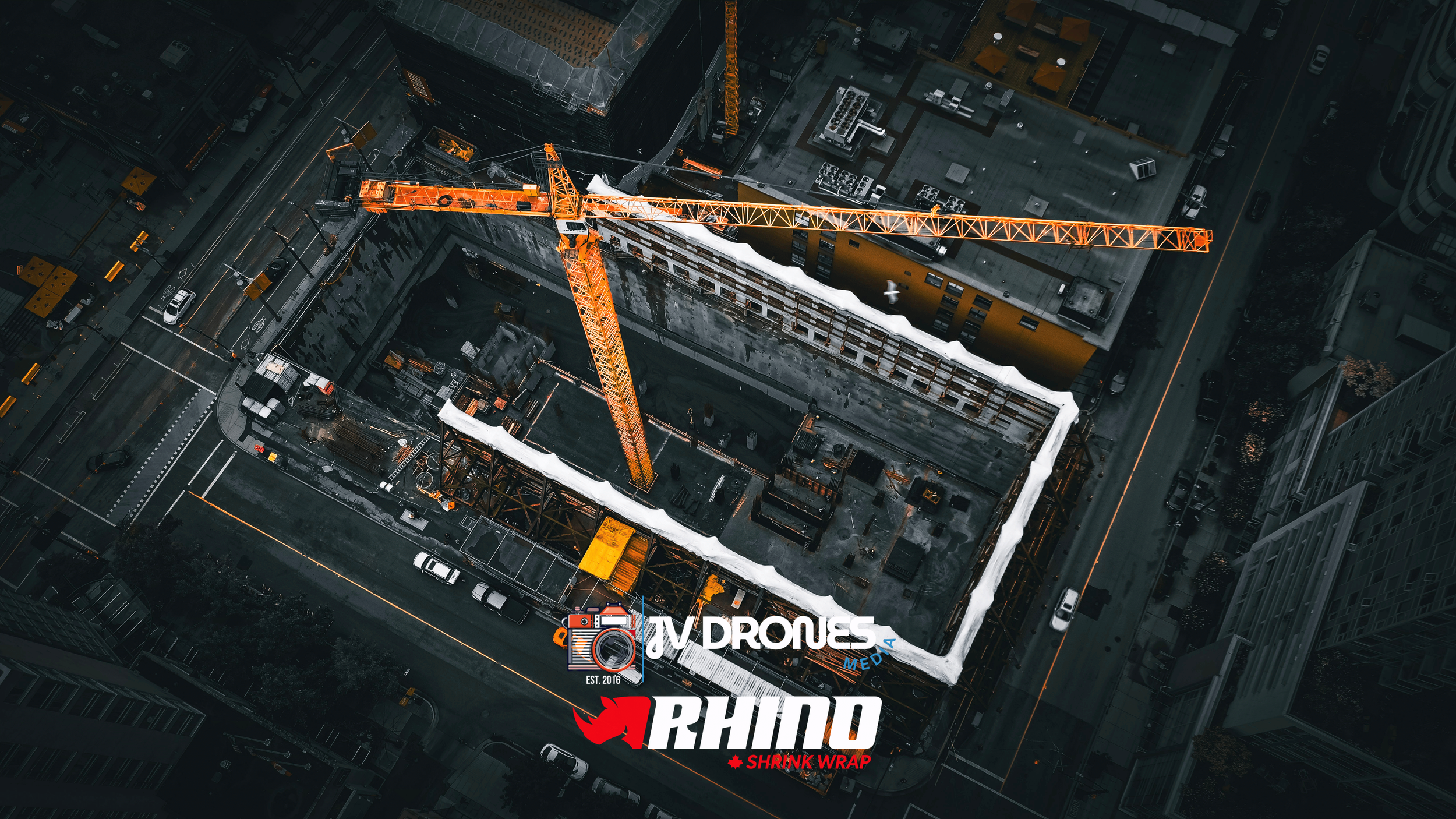 Top-down drone photo of tower crane and shrink wrap containment on a high-rise construction site in Vancouver, BC