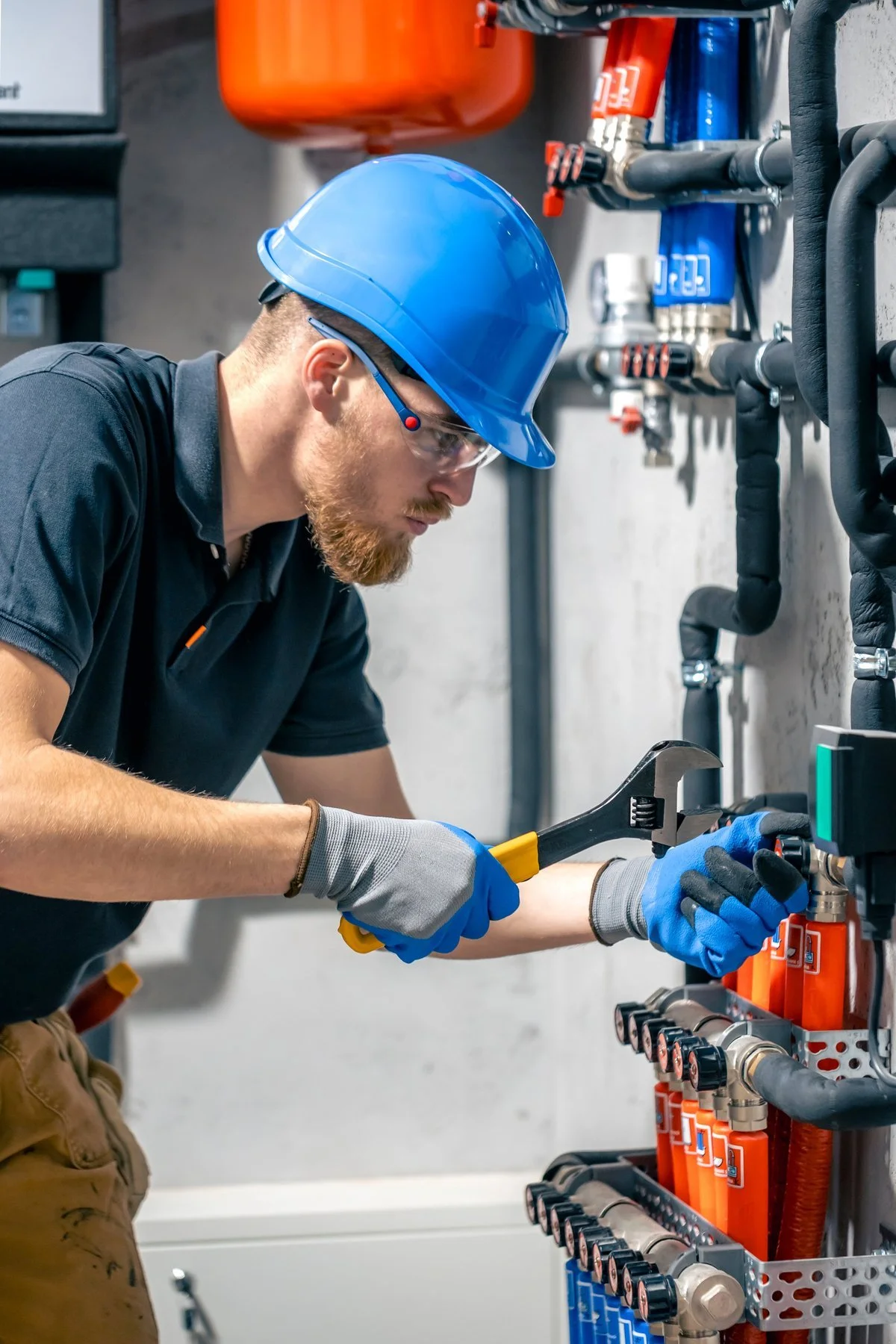 Home service technician wearing safety gear and working on a rooftop with tools