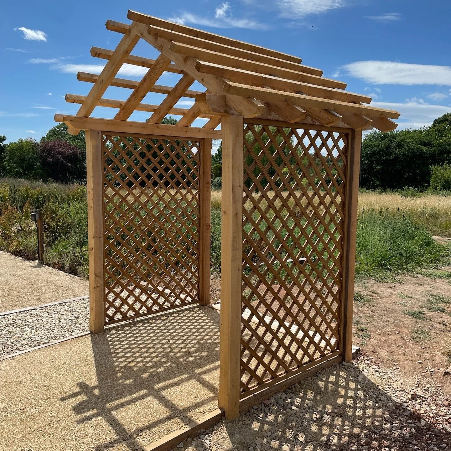 Beautiful garden Arbour made from cedar. Trellis has been thermally treated which is a chemical-free process that enhances durability and stability. Self-binding gravel path laid to connect the formal and working gardens. #landscaping #gardening #arb