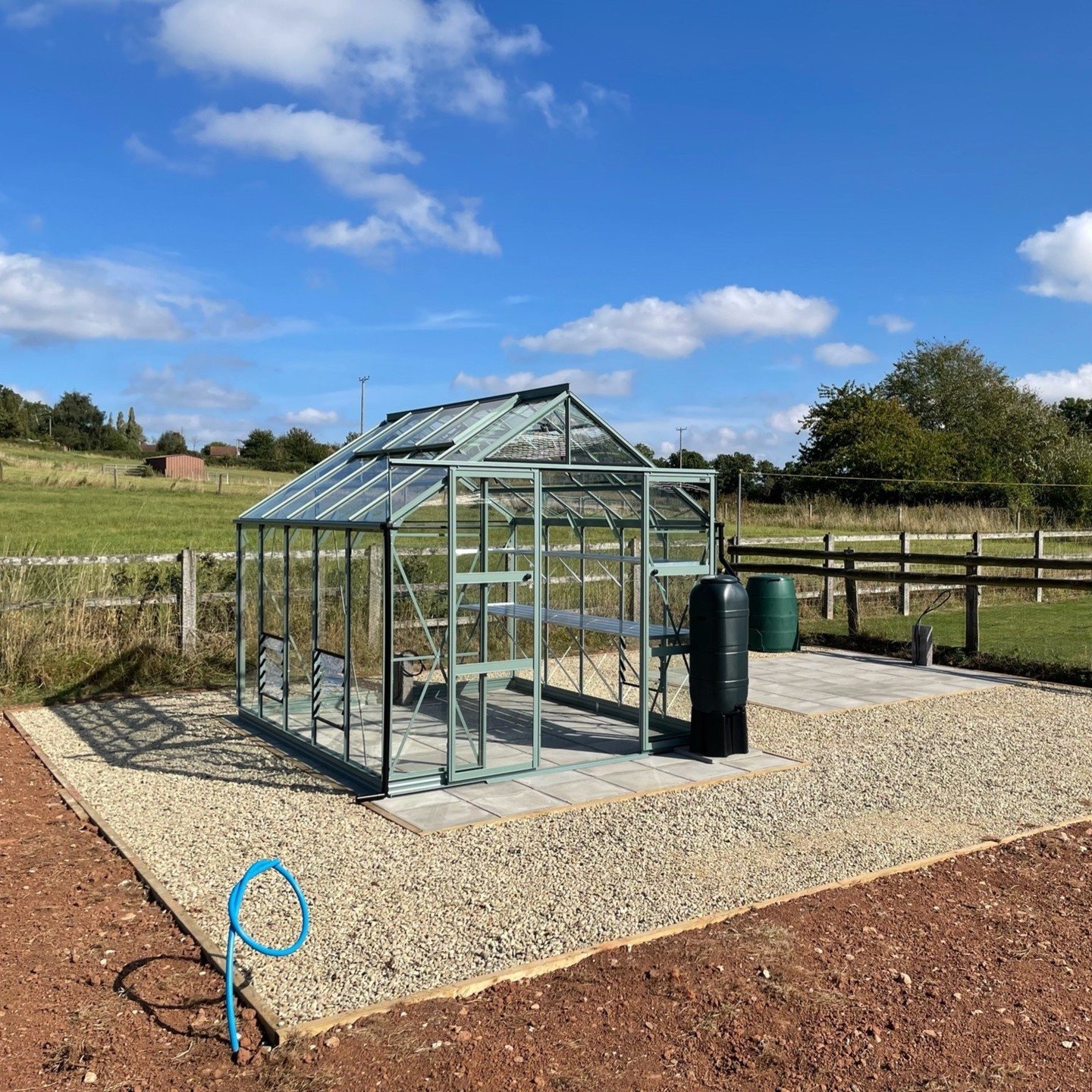 Working garden completed including installation of a Rhino 8x10ft greenhouse. Natural grey pavers laid for the greenhouse and shed. Water and electric supplies brought into location. Gravel areas finished with cotswold stone. #landscaping #gardening 