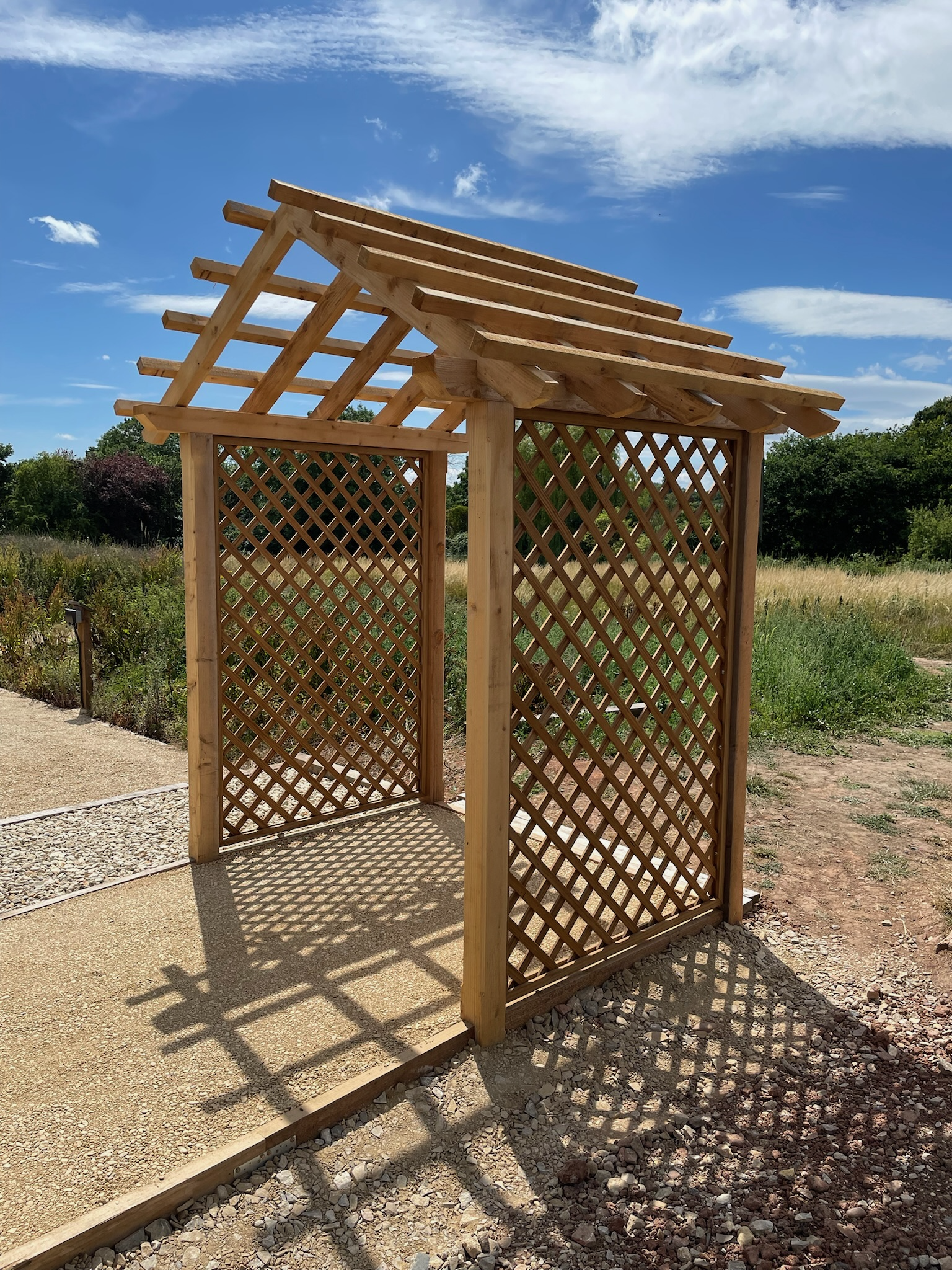 Arbour structure made from cedar and the trellis is made from thermally treated wood. Thermally treated wood is a chemical-free process that enhances durability and stability.