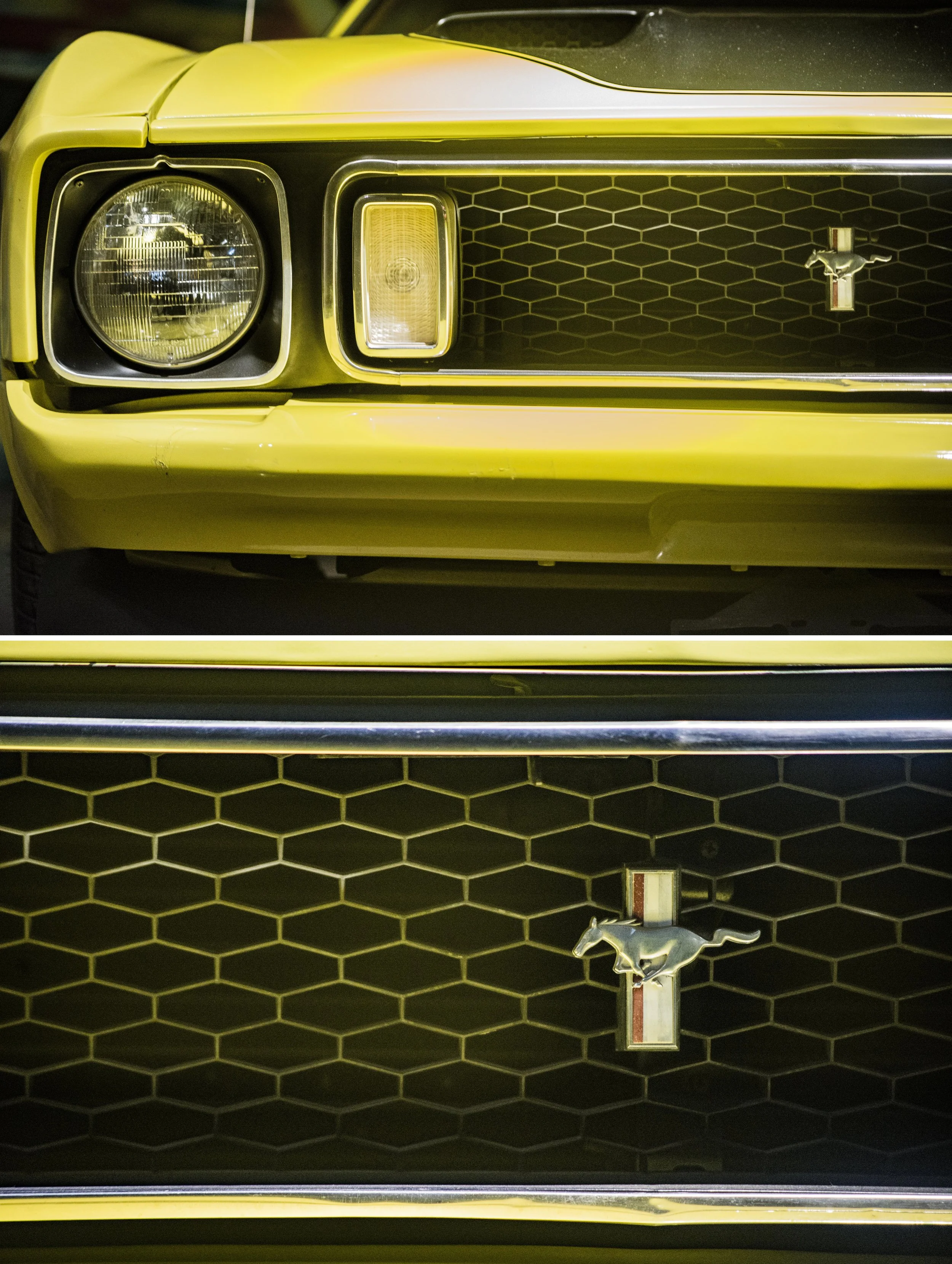 Close-up of a yellow vintage Ford Mustang car front grille and headlight, featuring the Mustang emblem with a running horse.
