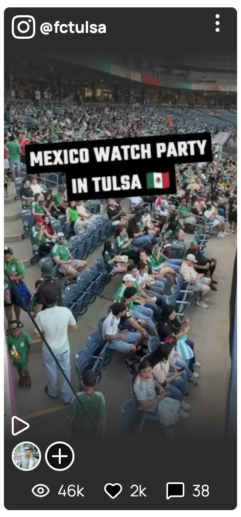 Crowd of people wearing Mexican jerseys and fan gear seated in an arena, attending a Mexico watch party in Tulsa.