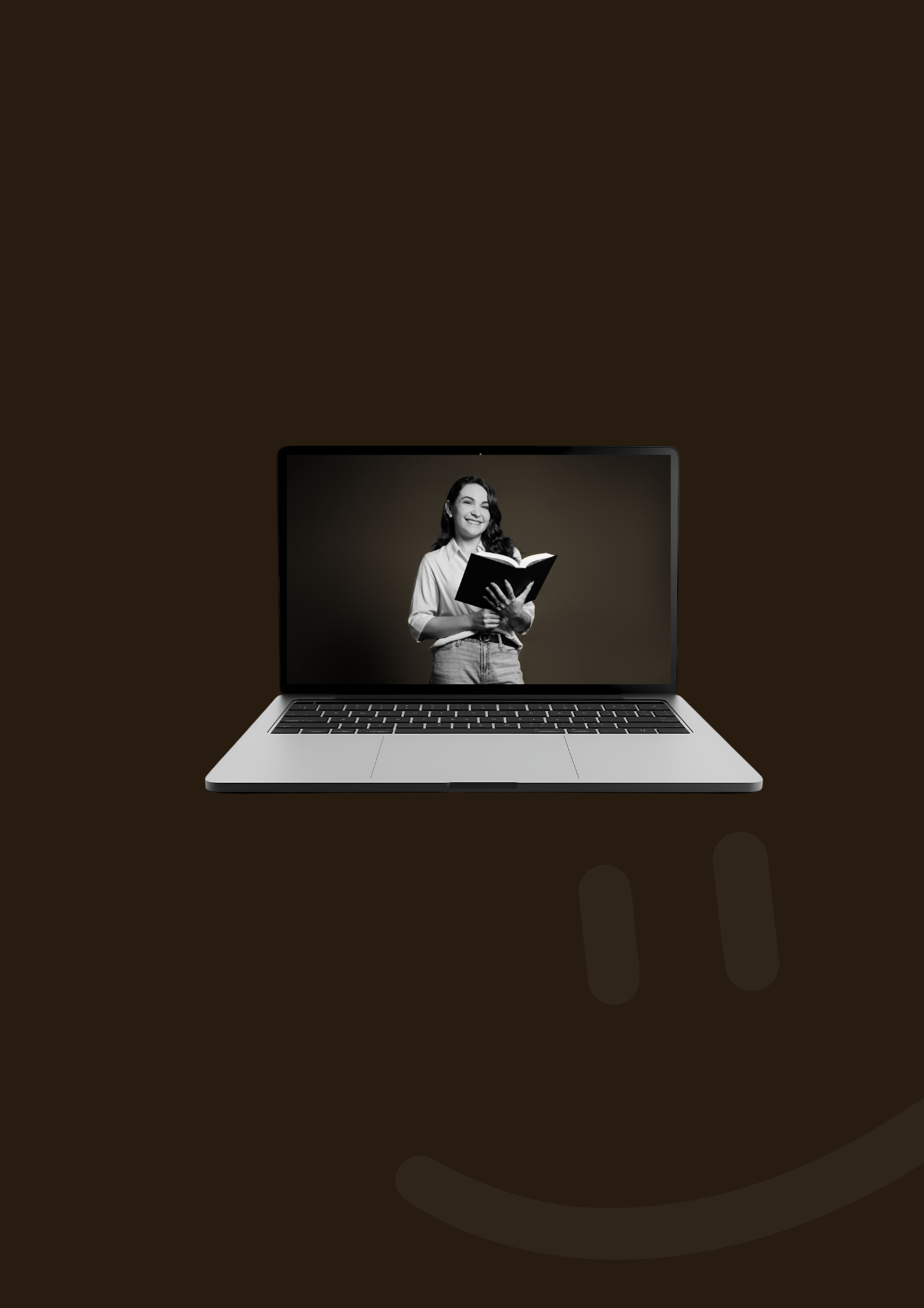 A person holding a book is displayed on a laptop screen, with the rest of the image being a dark background.