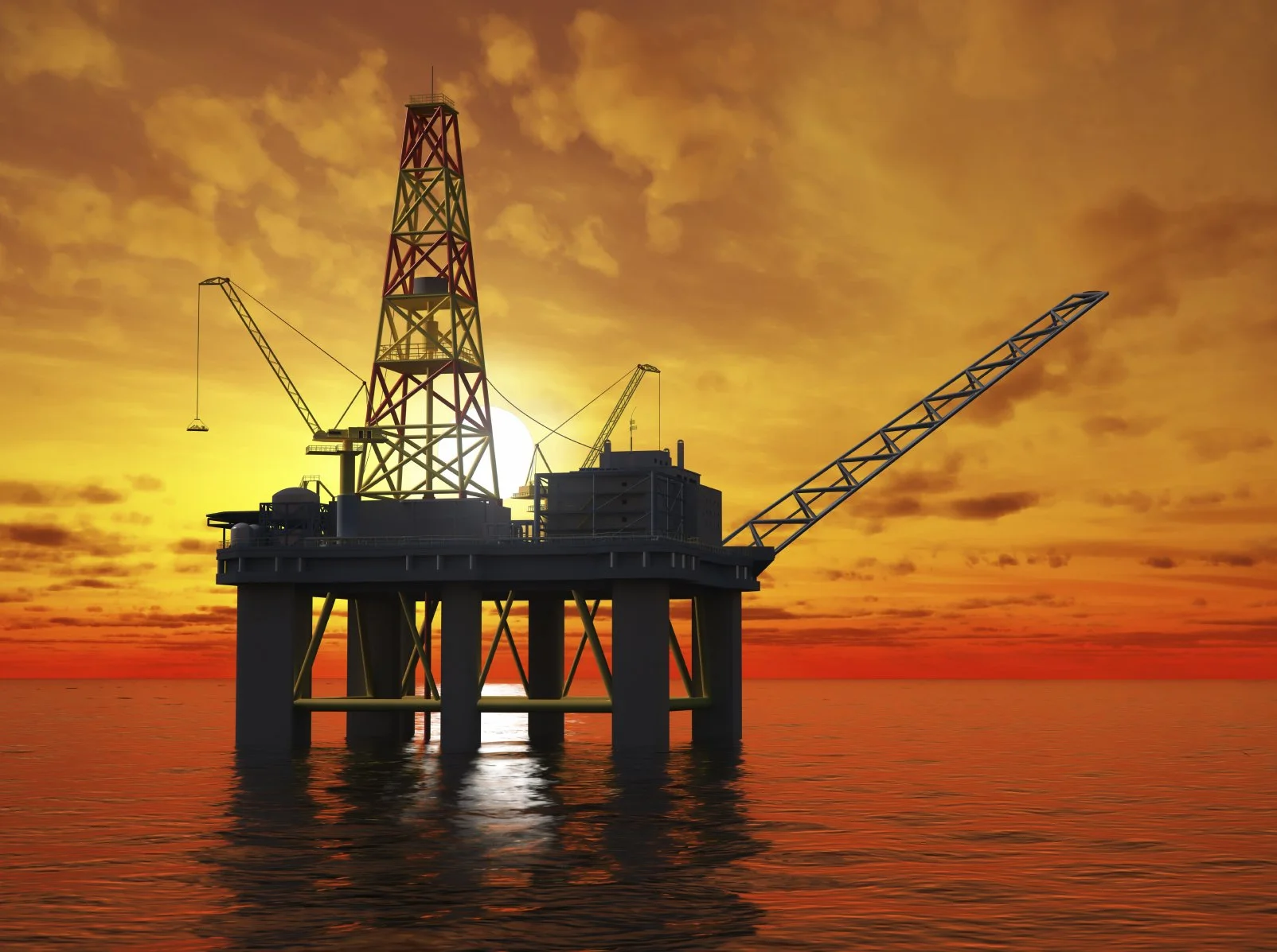 An offshore oil drilling platform silhouetted against a vibrant orange and yellow sunset over the ocean.