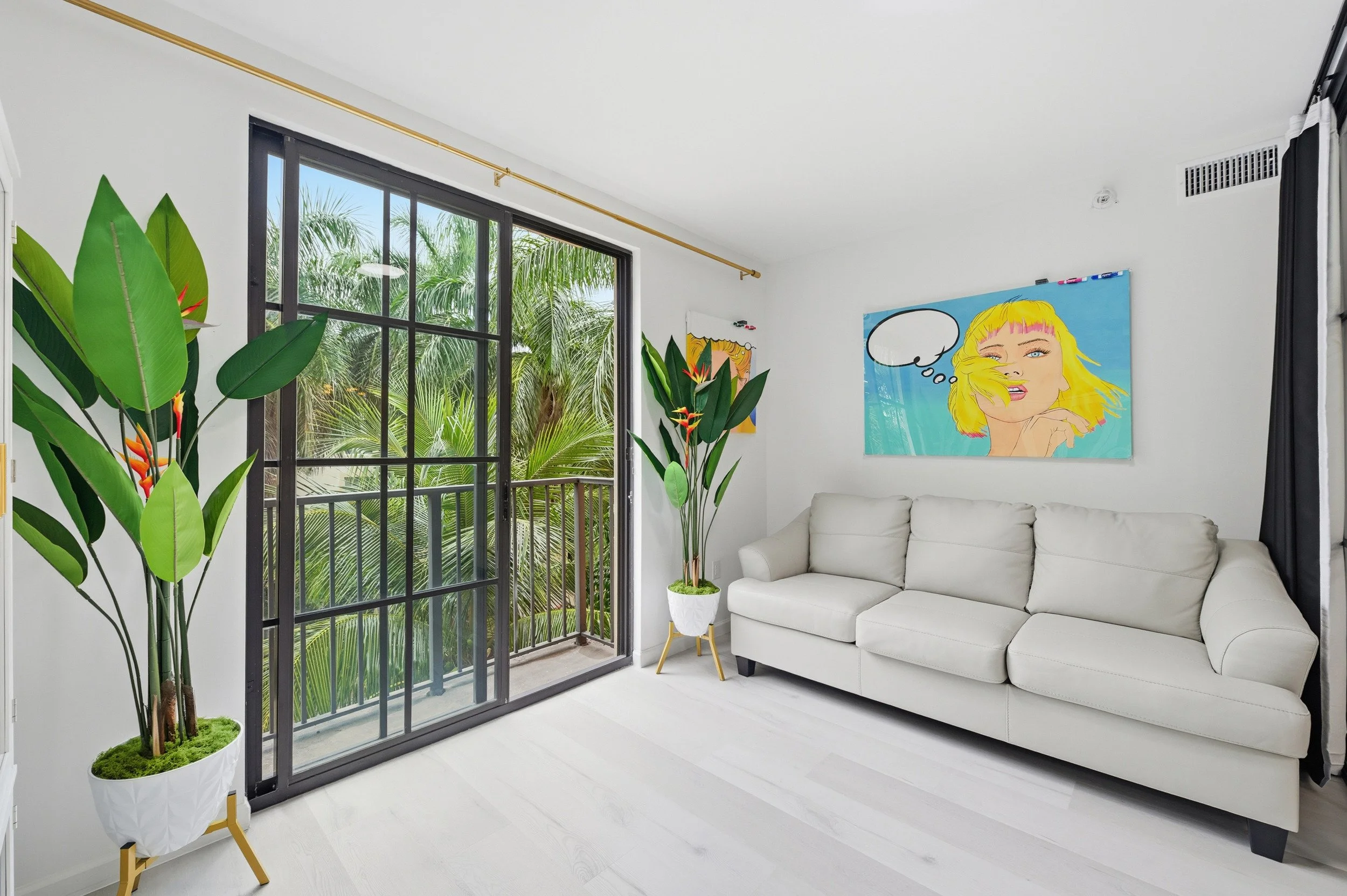 Bright sitting room with tropical views at the West Palm Beach vacation rental.
