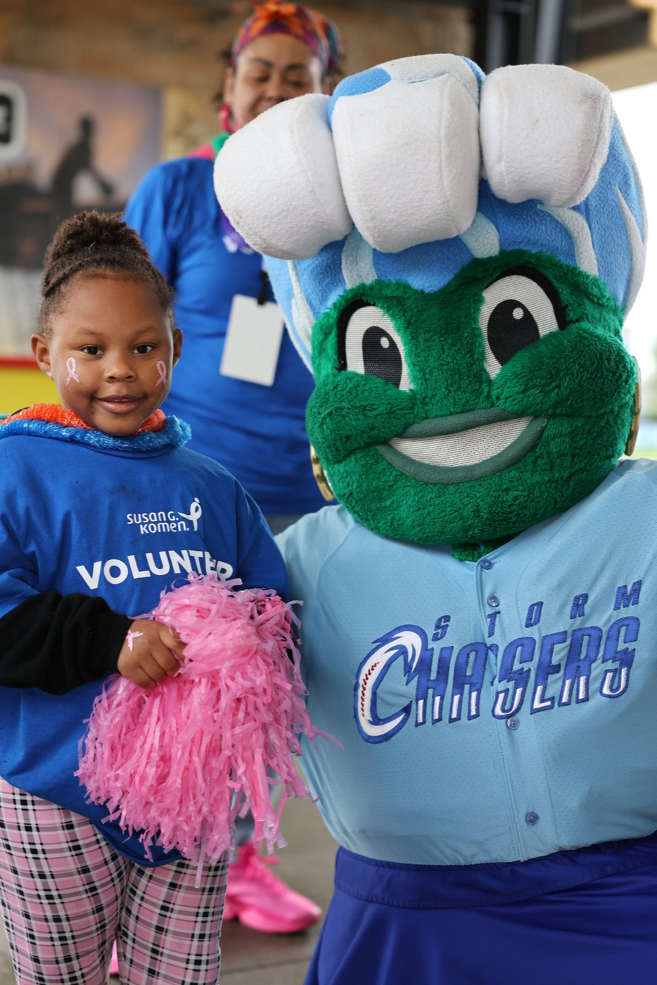A child greeting a costumed mascot at the walk.