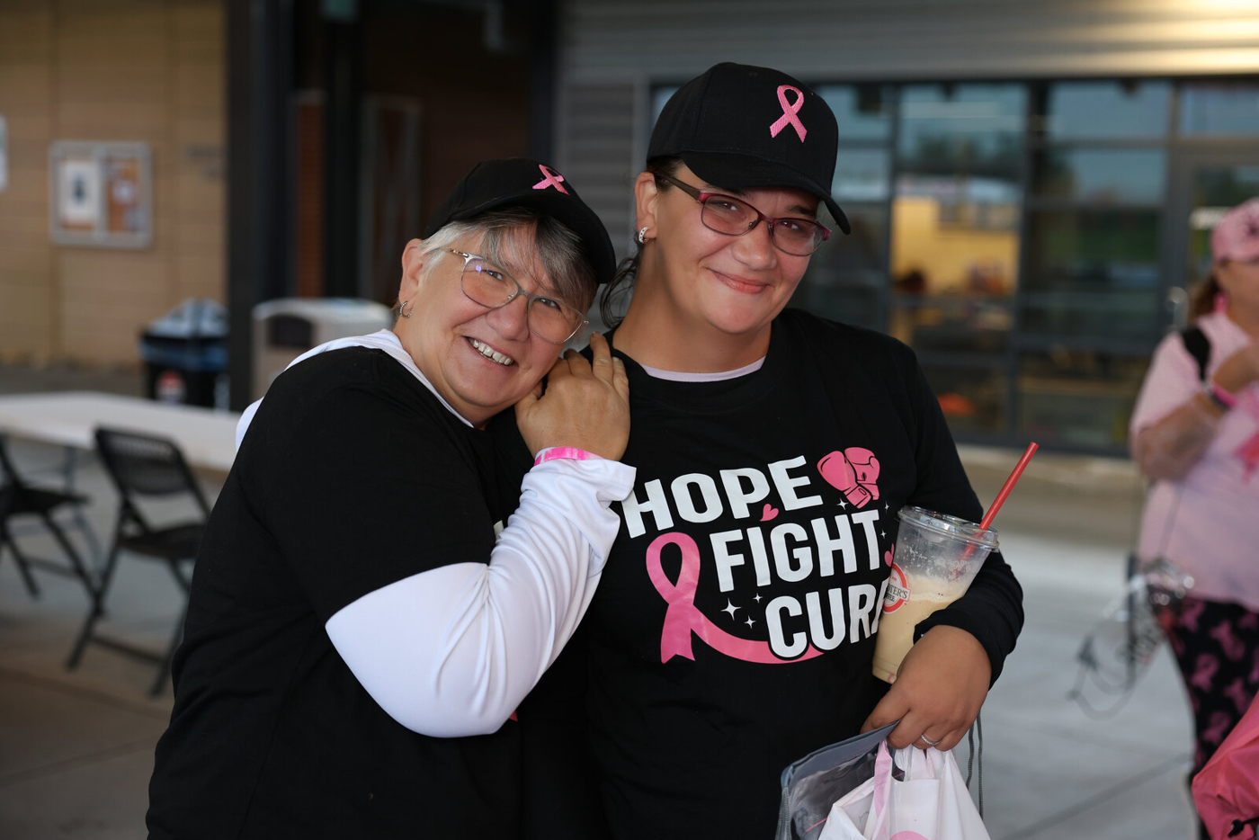 Two participants smiling together at the walk.