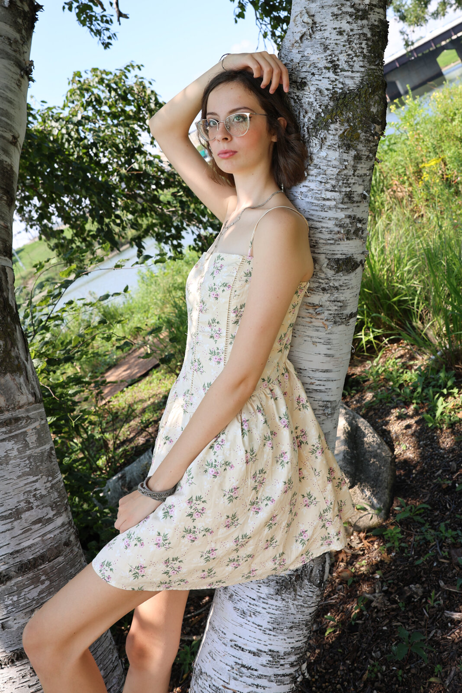 Senior portrait beside a birch tree.