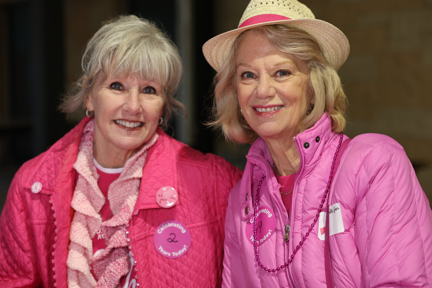 Two walk participants wearing pink jackets.