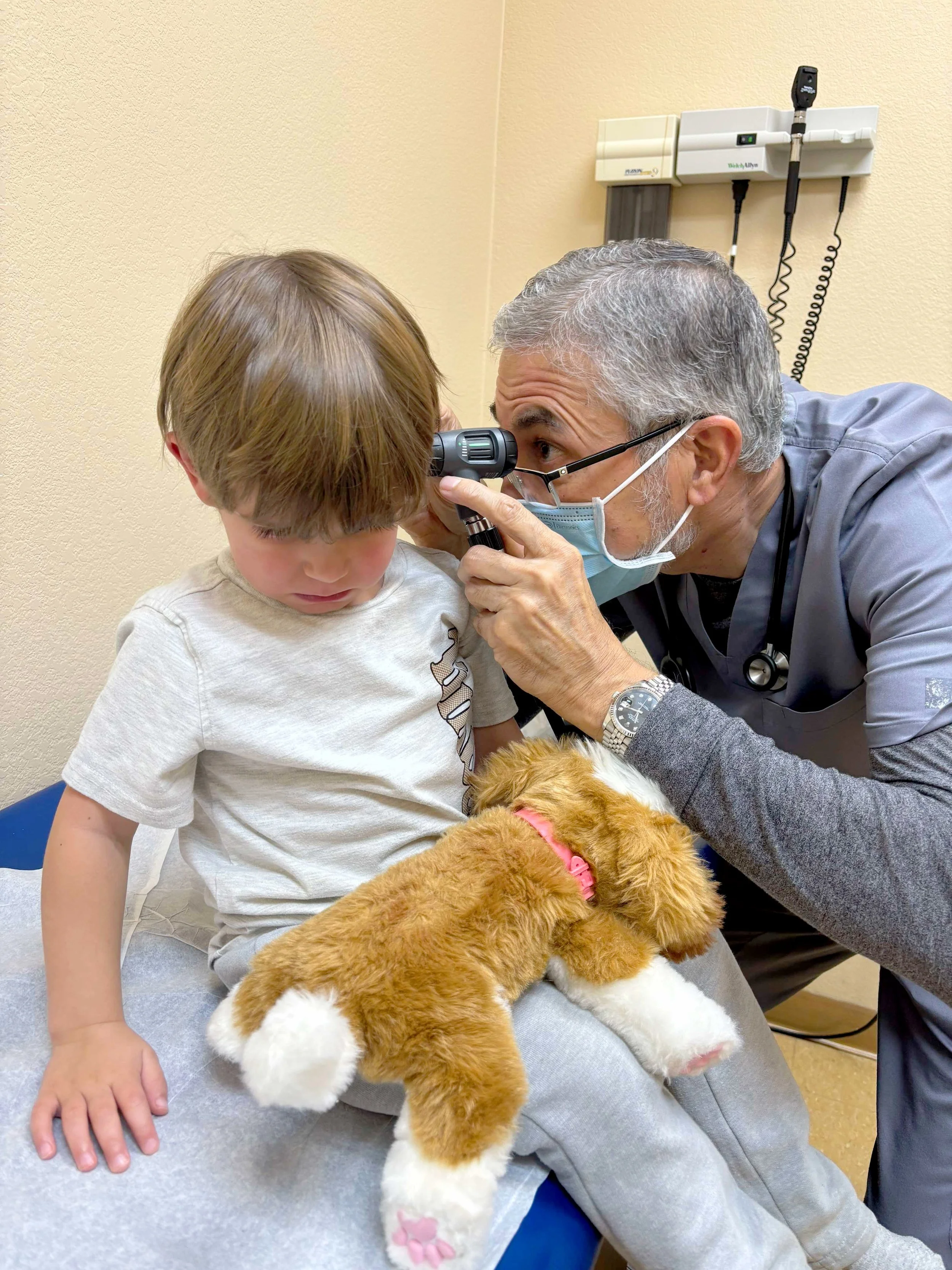 Dr. Muhammad Mirza examining a patient at Carrollton Pediatrics.