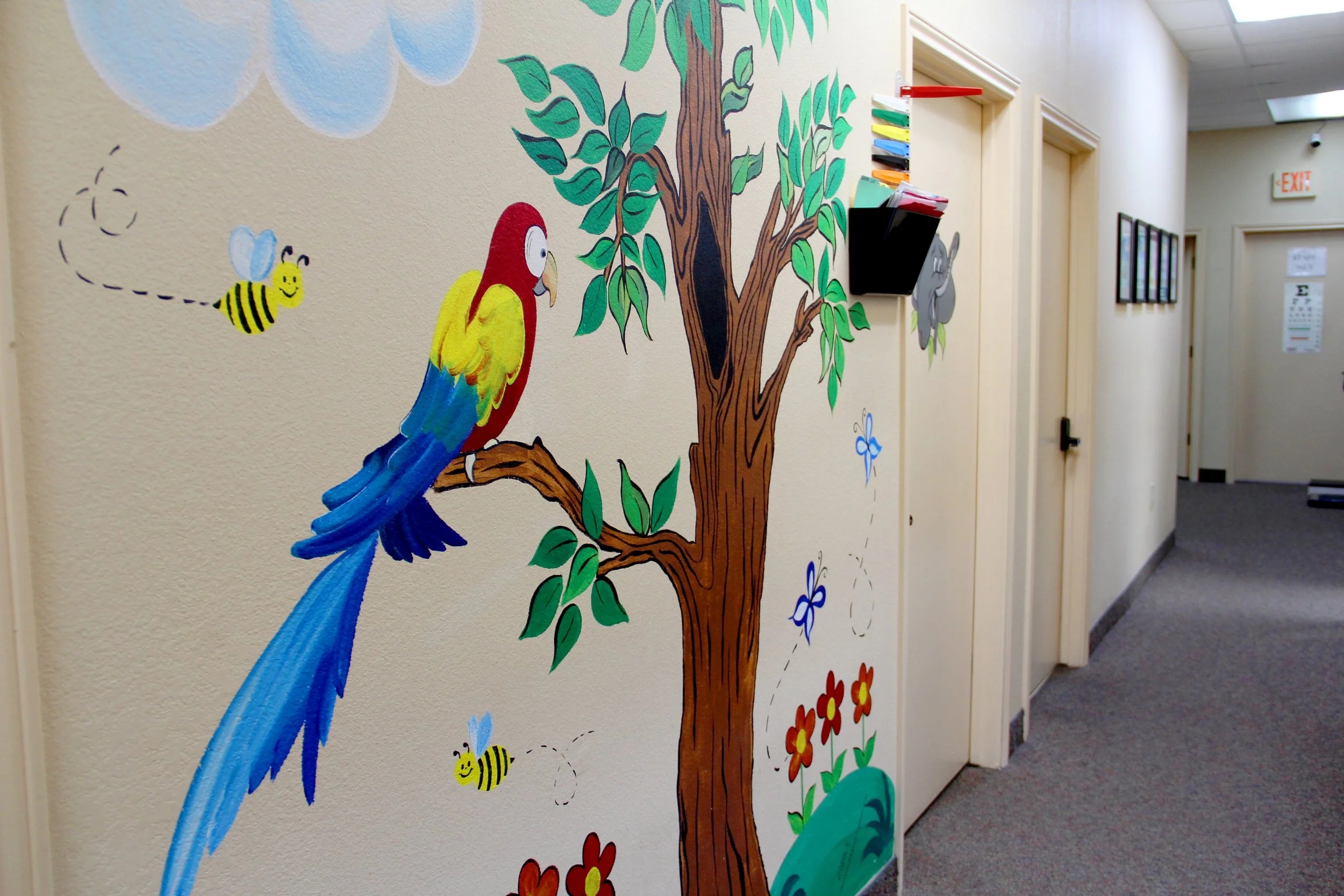 Colorful artwork handpainted on the walls at Carrollton Pediatrics