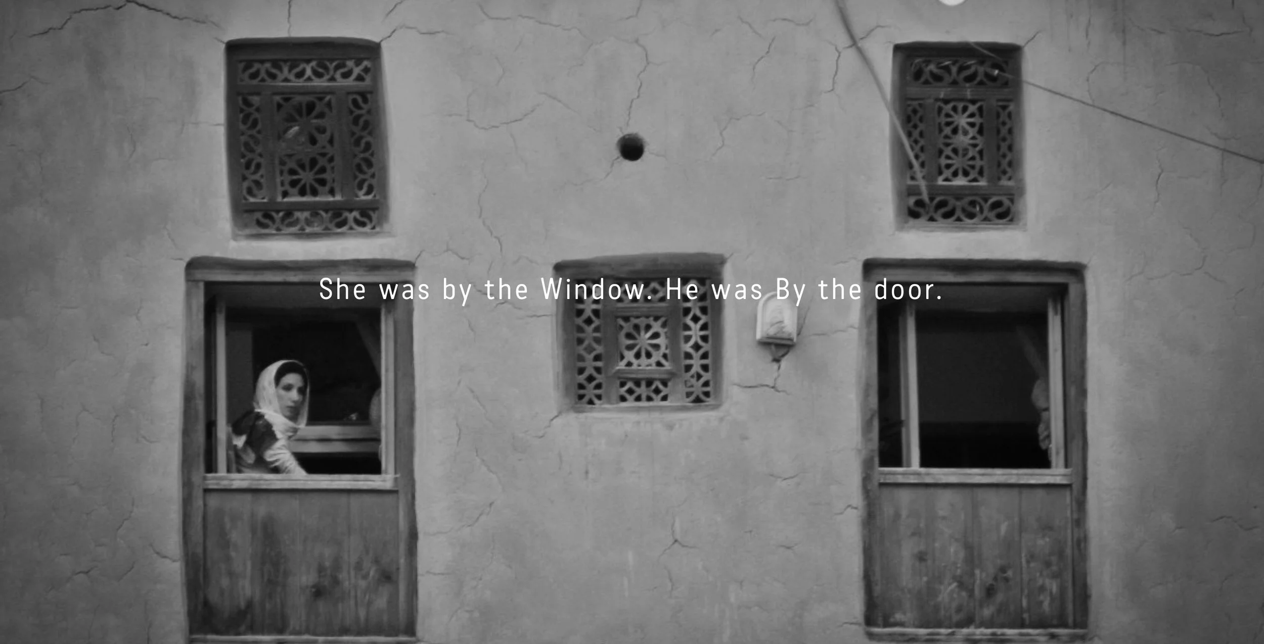 She was by the window. He was by the door.