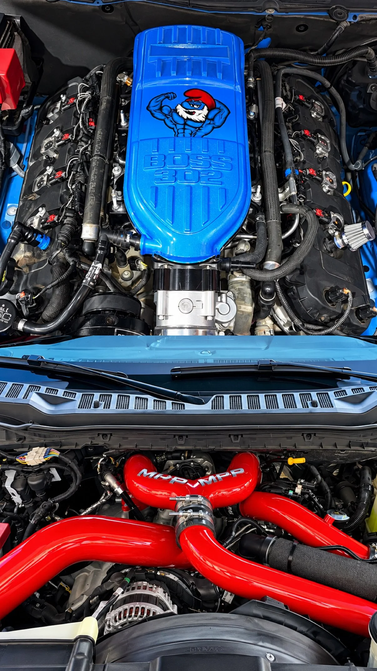 Engine bay of a car with a blue HEMI engine cover featuring a muscular Santa Claus graphic and the text "BOSS 302," and red turbo intercooler pipes with MOPAR branding.