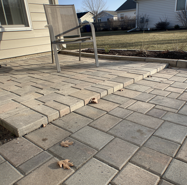 frost heaved paver patio with raised ridge and shifted units